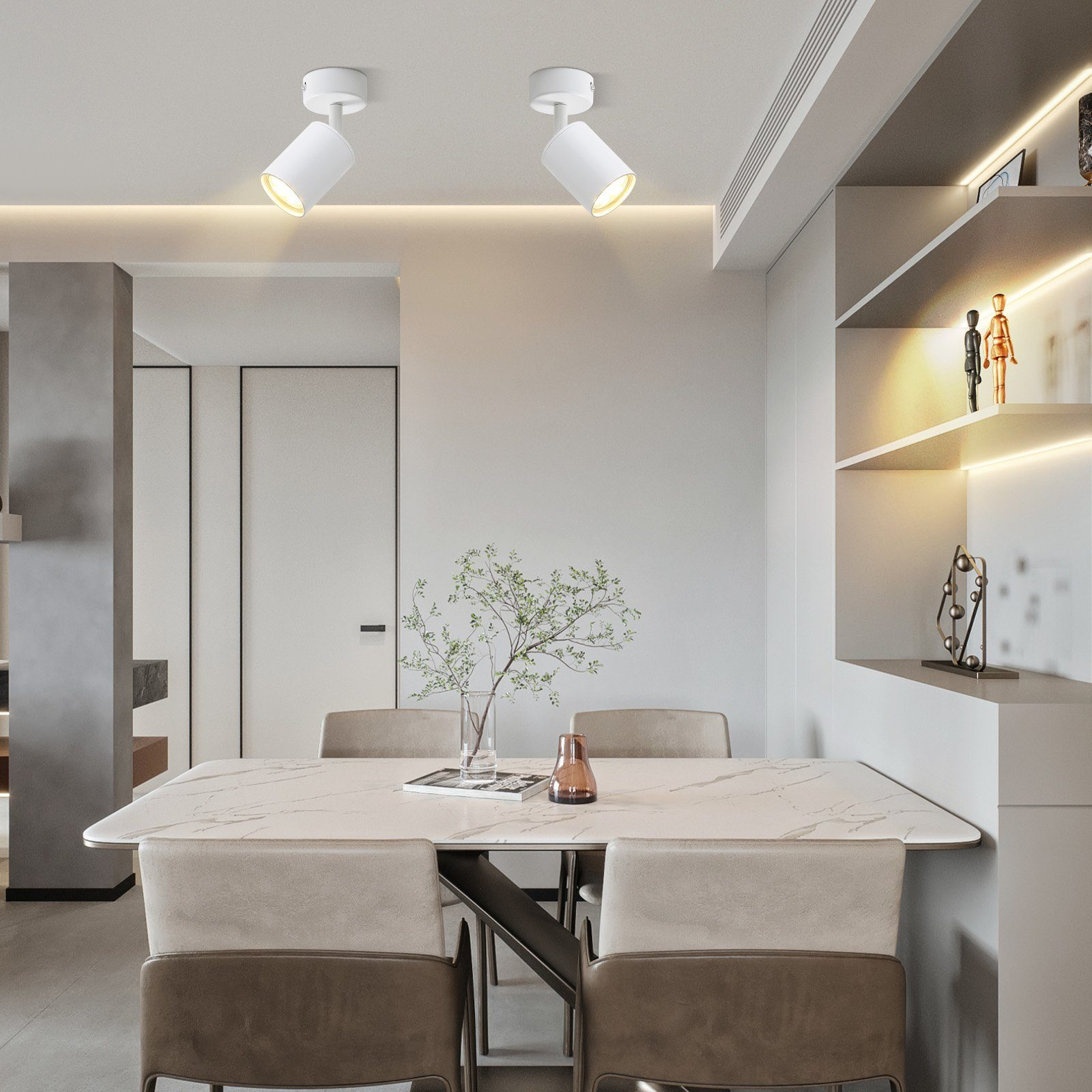 Dwa białe reflektory na suficie nad stołem jadalnym. Światła skierowane są w dół.