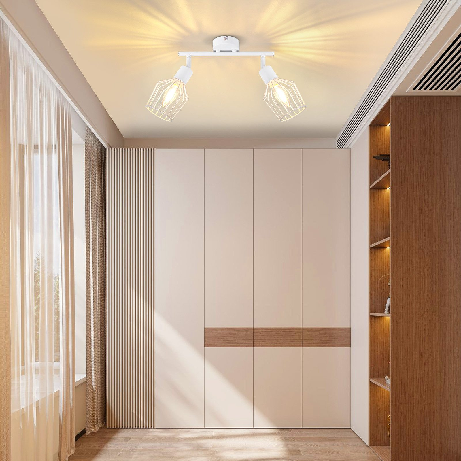 Due faretti bianchi montati su un soffitto bianco in una stanza.