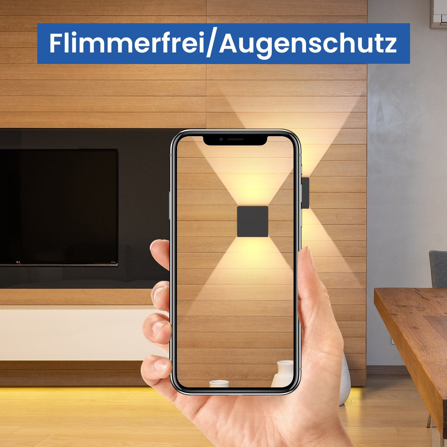 Mano che tiene un telefono che mostra luci a parete. Parete in legno e tavolo sullo sfondo.