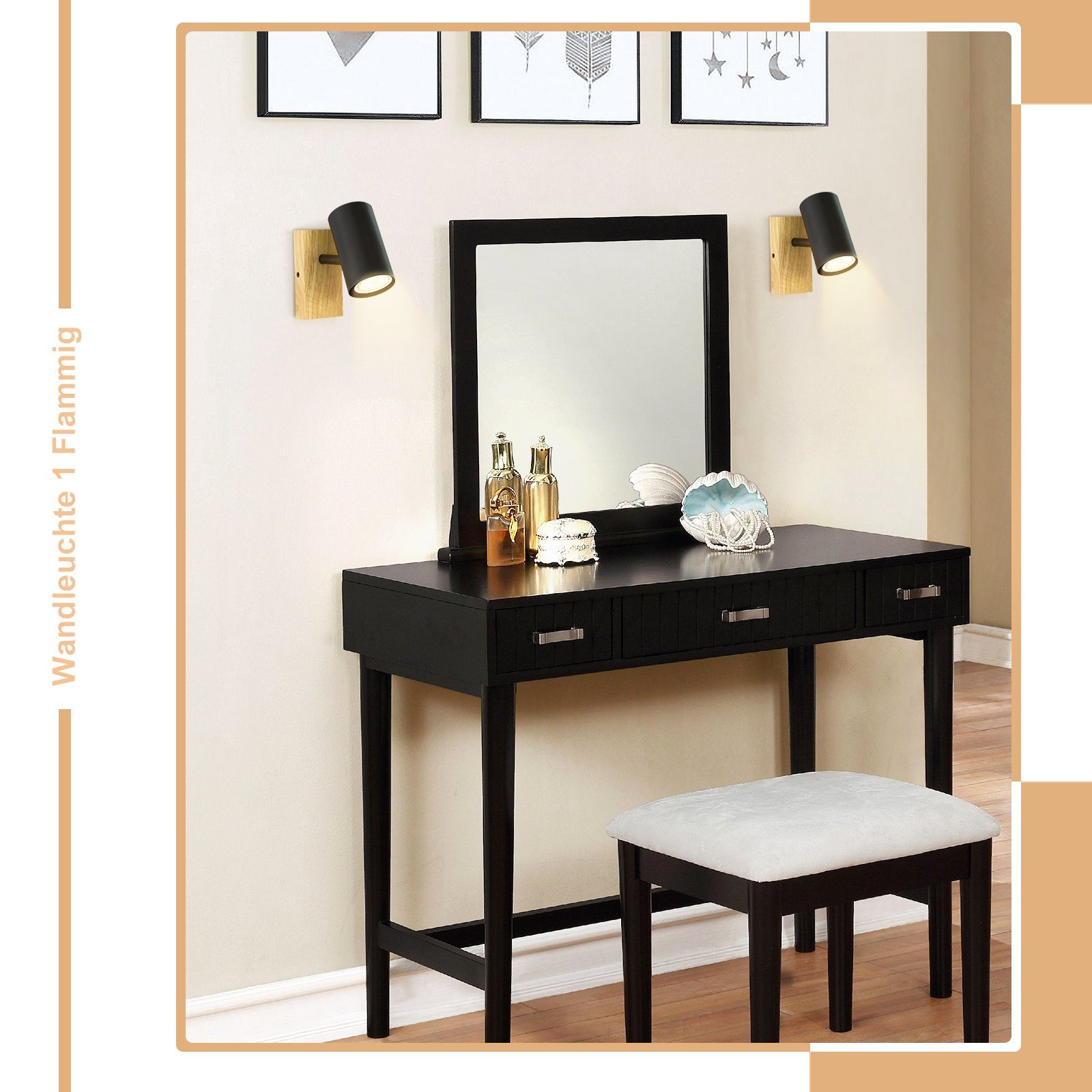Toeletta nera con specchio, sgabello, due applique e decorazioni.