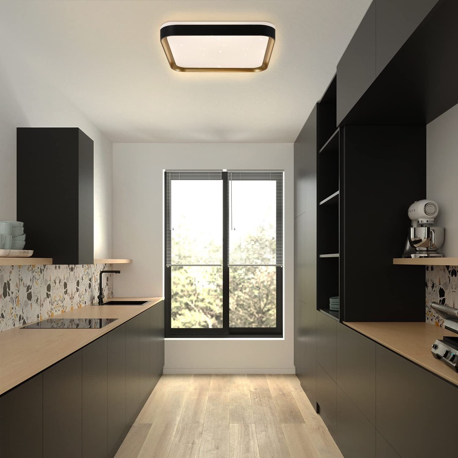 Una cucina moderna con mobili neri, piani di lavoro in legno e una luce a soffitto.