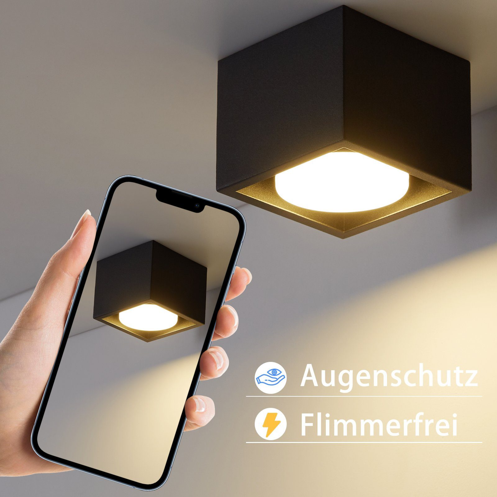 Viene mostrata una plafoniera quadrata nera. Una mano tiene un telefono, mostrando la stessa luce.