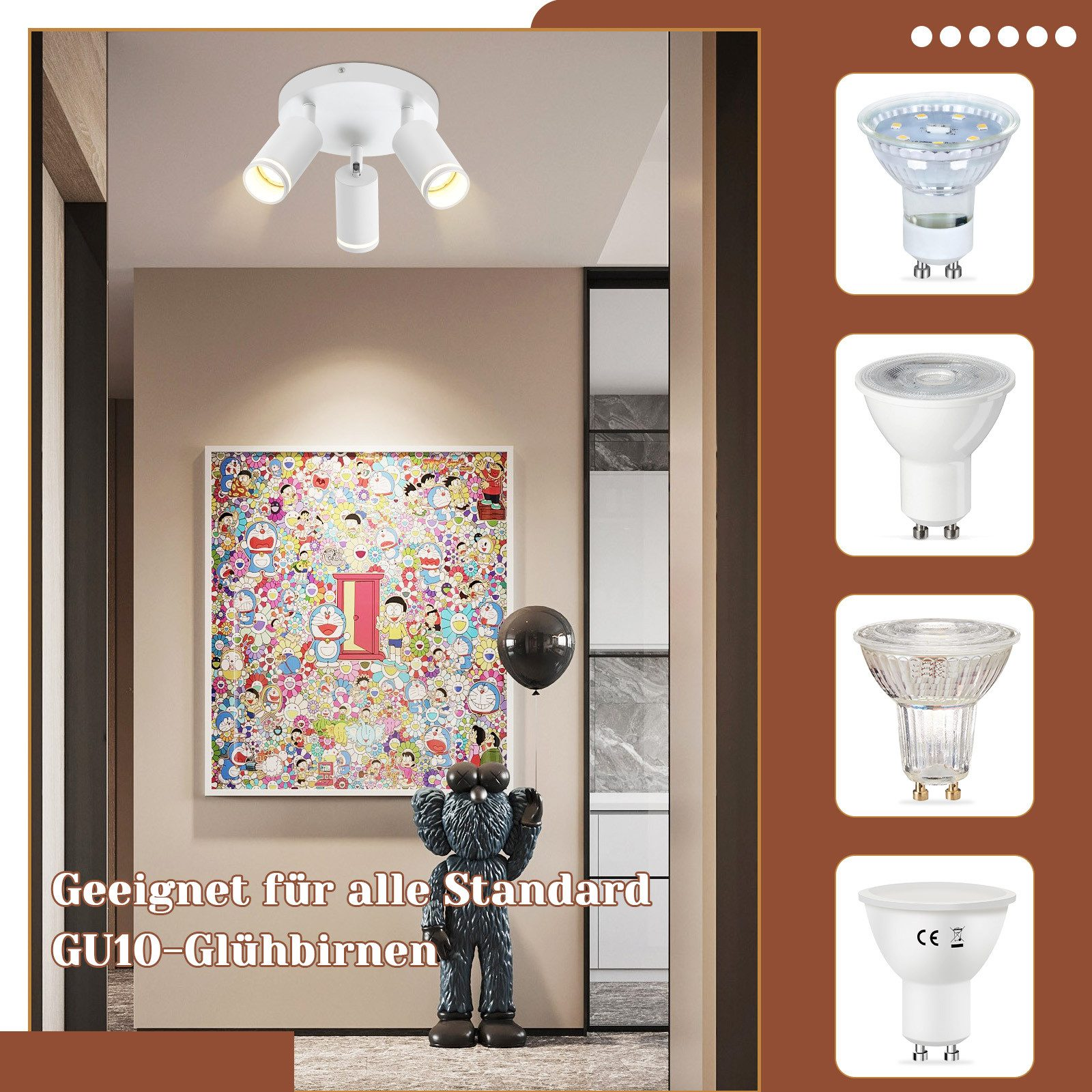 Lampada da soffitto bianca con tre lampade regolabili. Opera d'arte colorata e palloncino nero sullo sfondo.