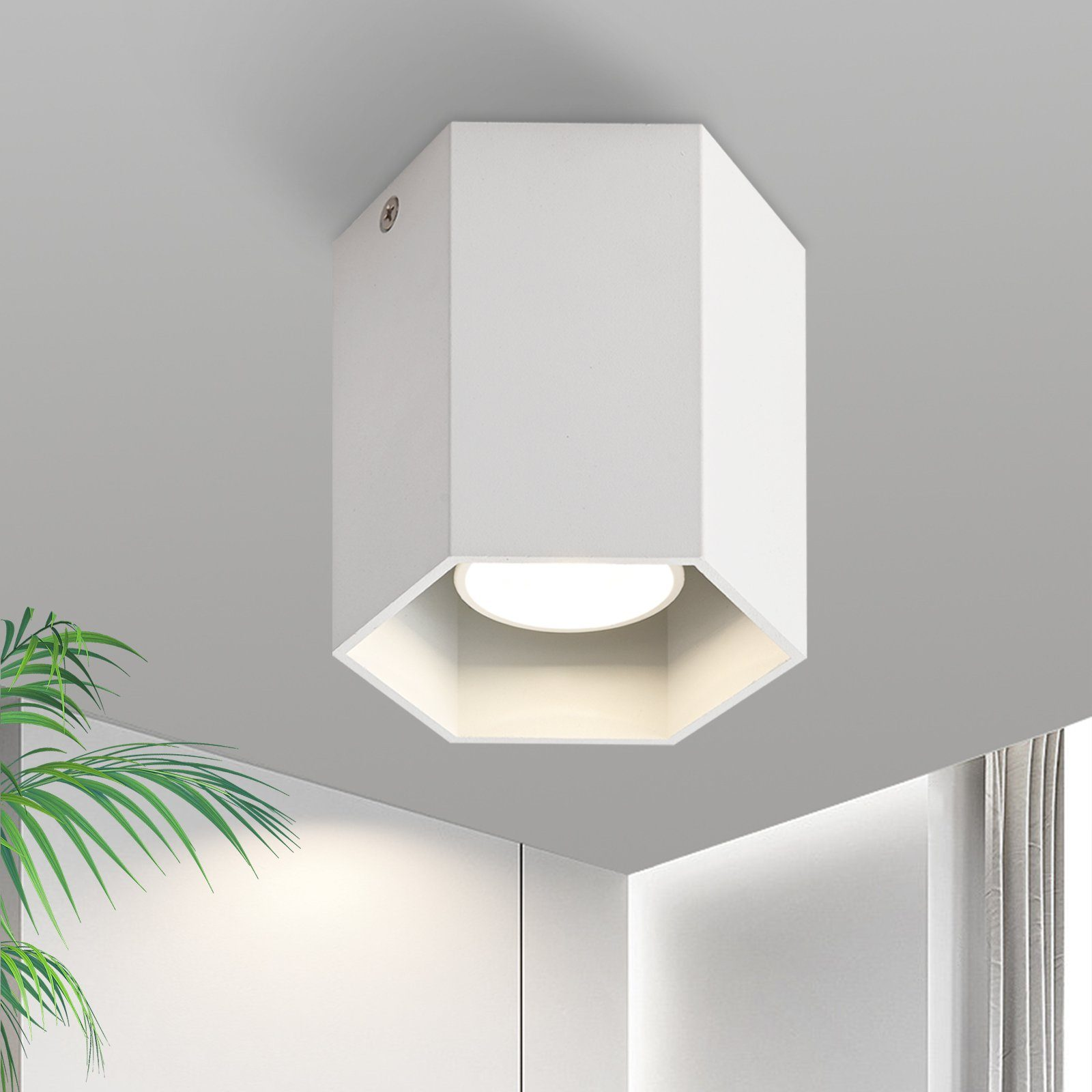 Un apparecchio di illuminazione a soffitto esagonale bianco con una sorgente luminosa.