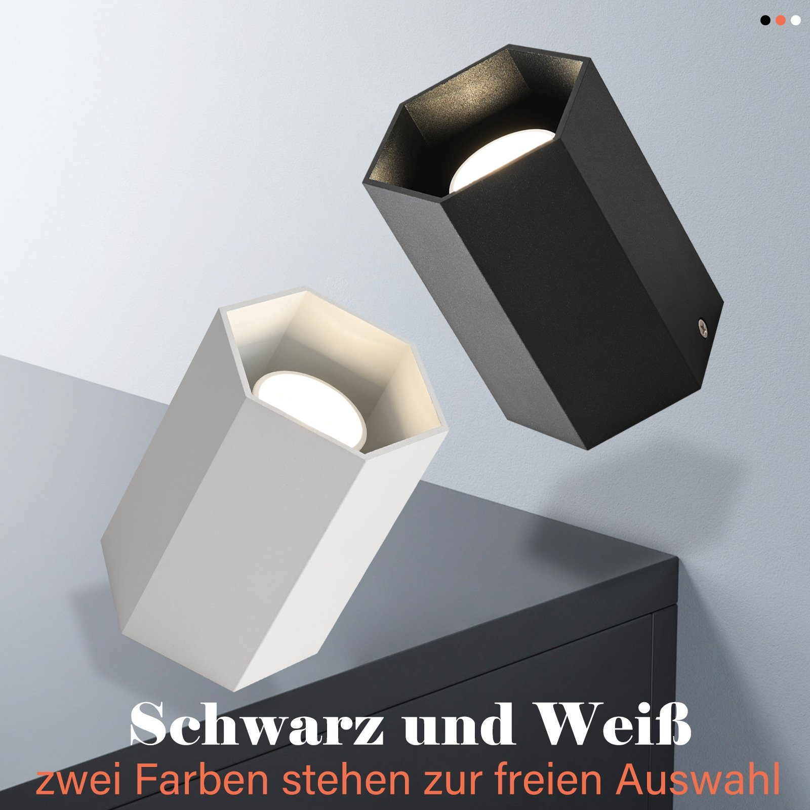 Due lampade esagonali, una bianca, una nera, su una superficie scura. Testo: Schwarz und Weiß.