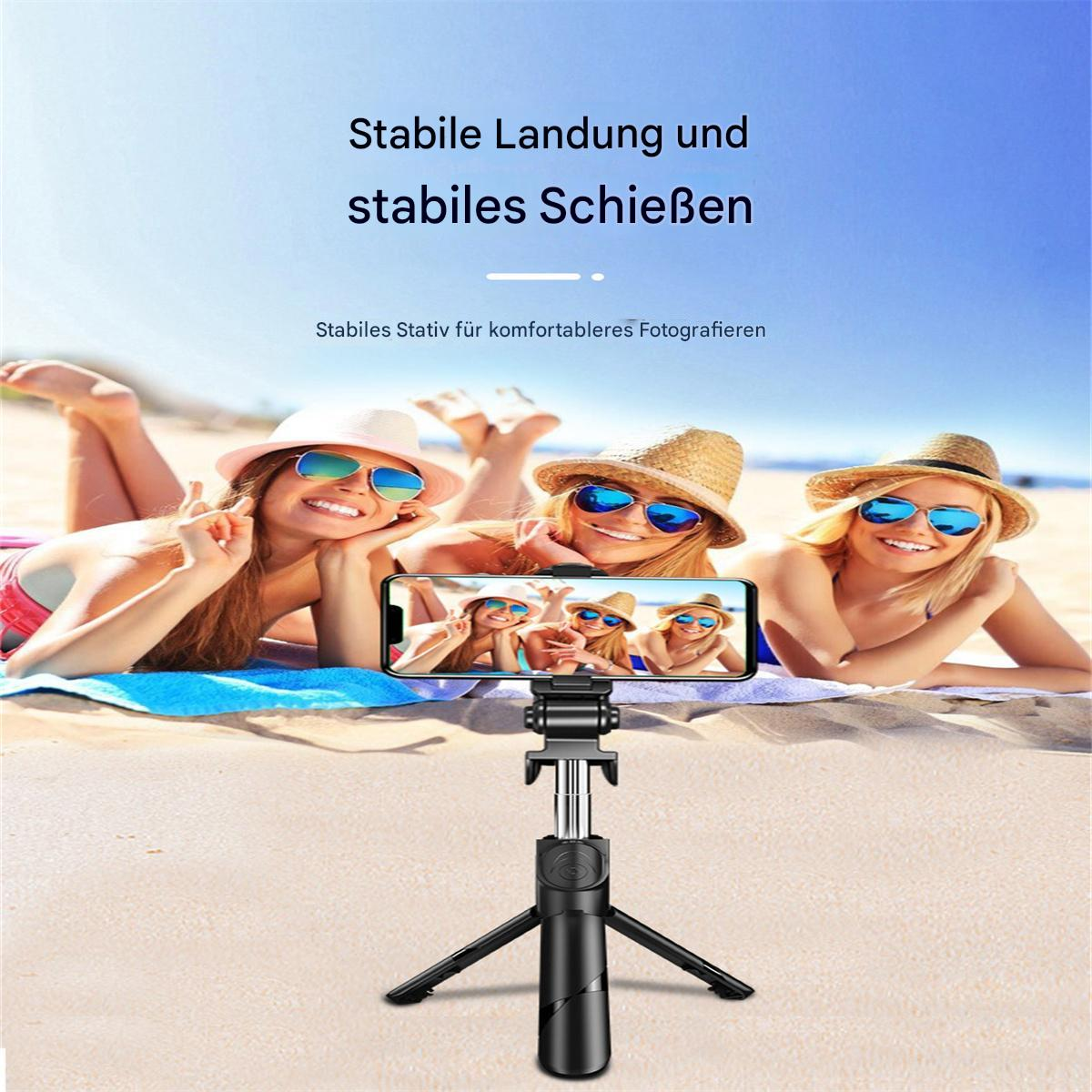 Drei Frauen mit Sonnenbrillen machen ein Foto am Strand mit einem Telefon auf einem Stativ.