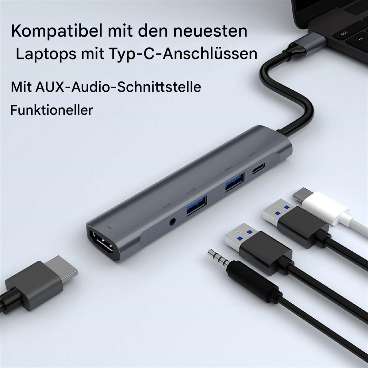 Grauer USB-C-Hub mit Anschlüssen an einem Laptop. Kabel umfassen HDMI, USB, Audio und USB-C.