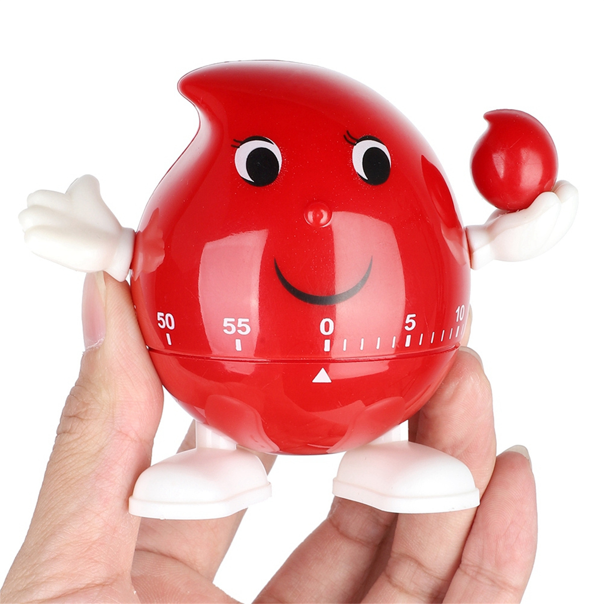 Ein roter Timer in Tropfenform mit einem lächelnden Gesicht, gehalten in einer Hand.