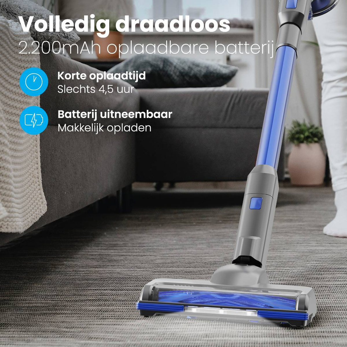 A cordless vacuum cleaner with a blue and gray body is being used on carpet.