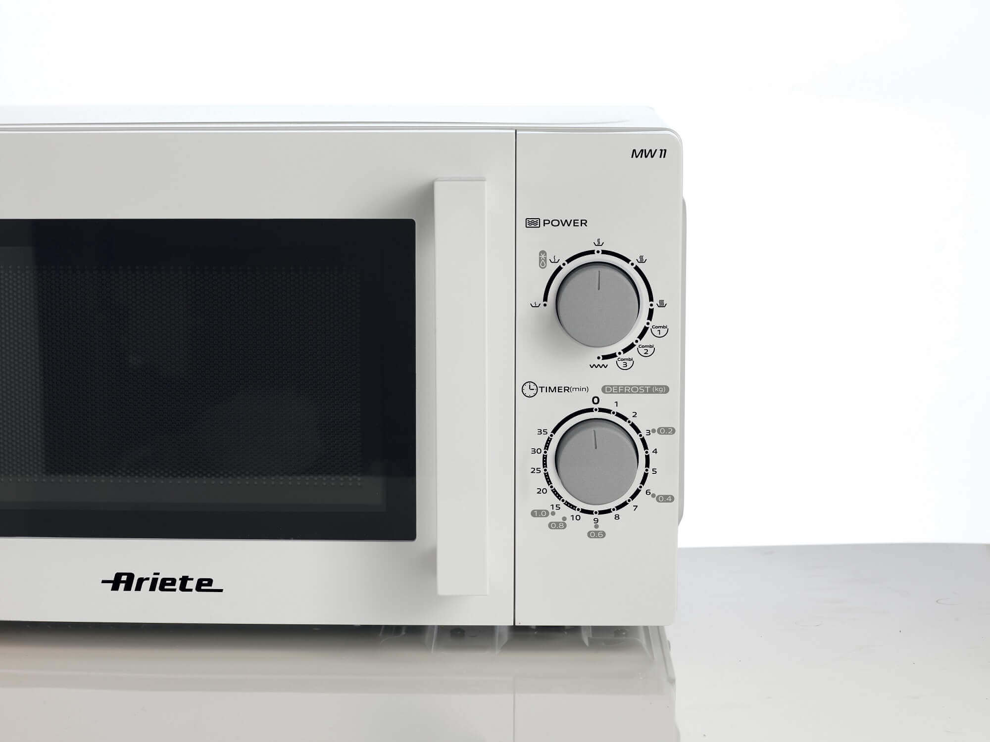 Een witte magnetron. Bedieningselementen: vermogensniveau, timer en ontdooimogelijkheden. Merk Ariete zichtbaar.