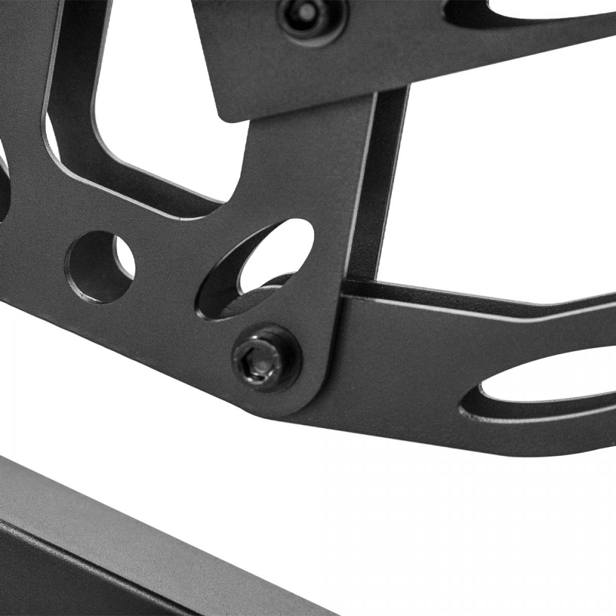 Close-up of black metal framework with screws, angled against a white background.
