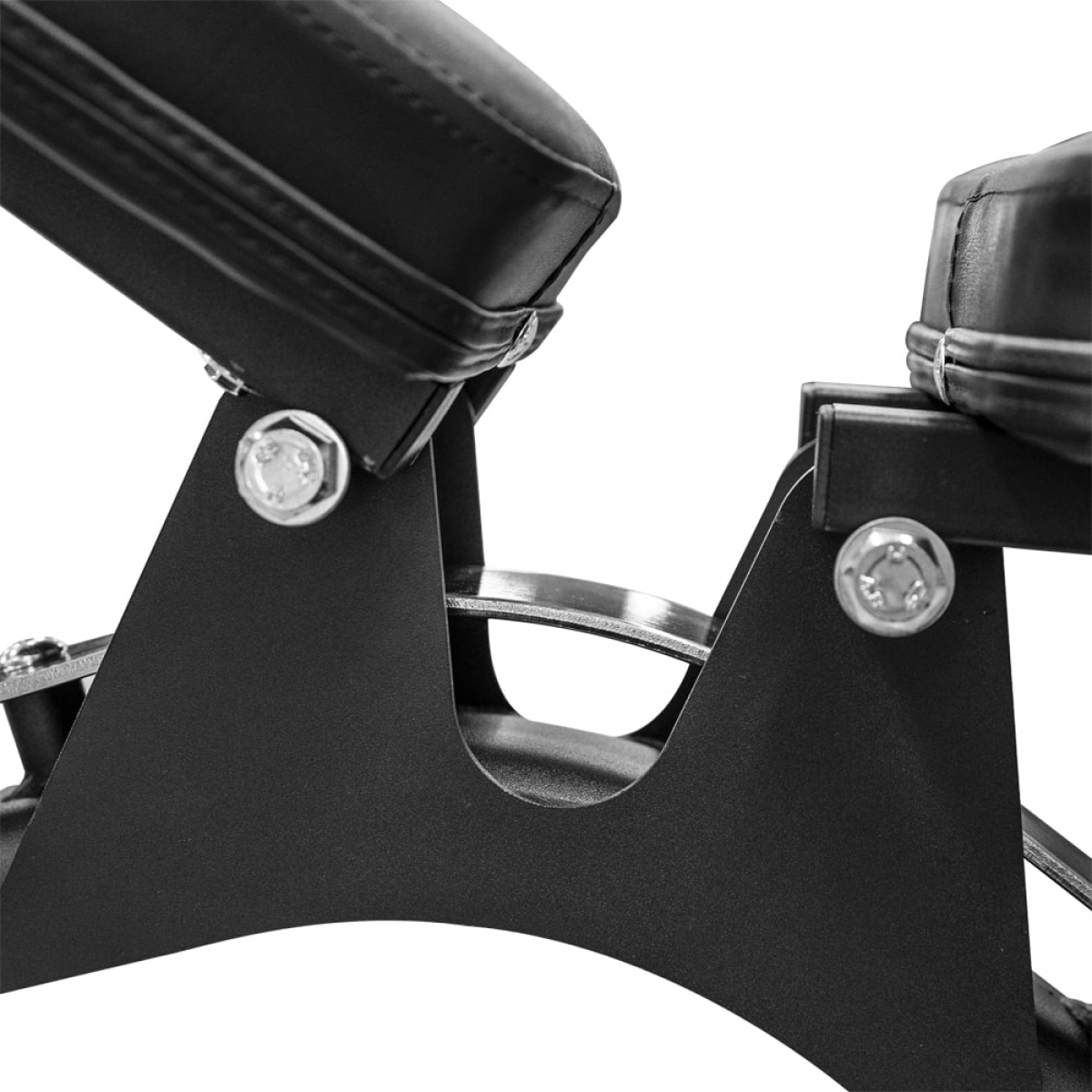 A close-up of a weight bench. Features black leather padding, and black metal frame.