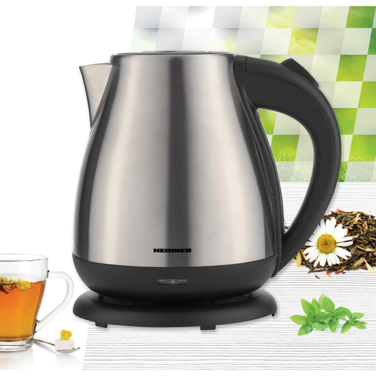 Silver electric kettle with black handle. Tea and ingredients are beside it.