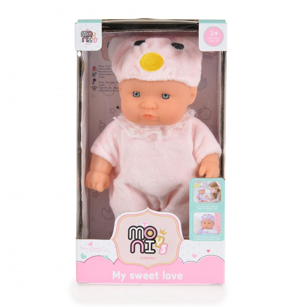 Eine Babypuppe in einer Box mit rosa Hut und Kleidung.