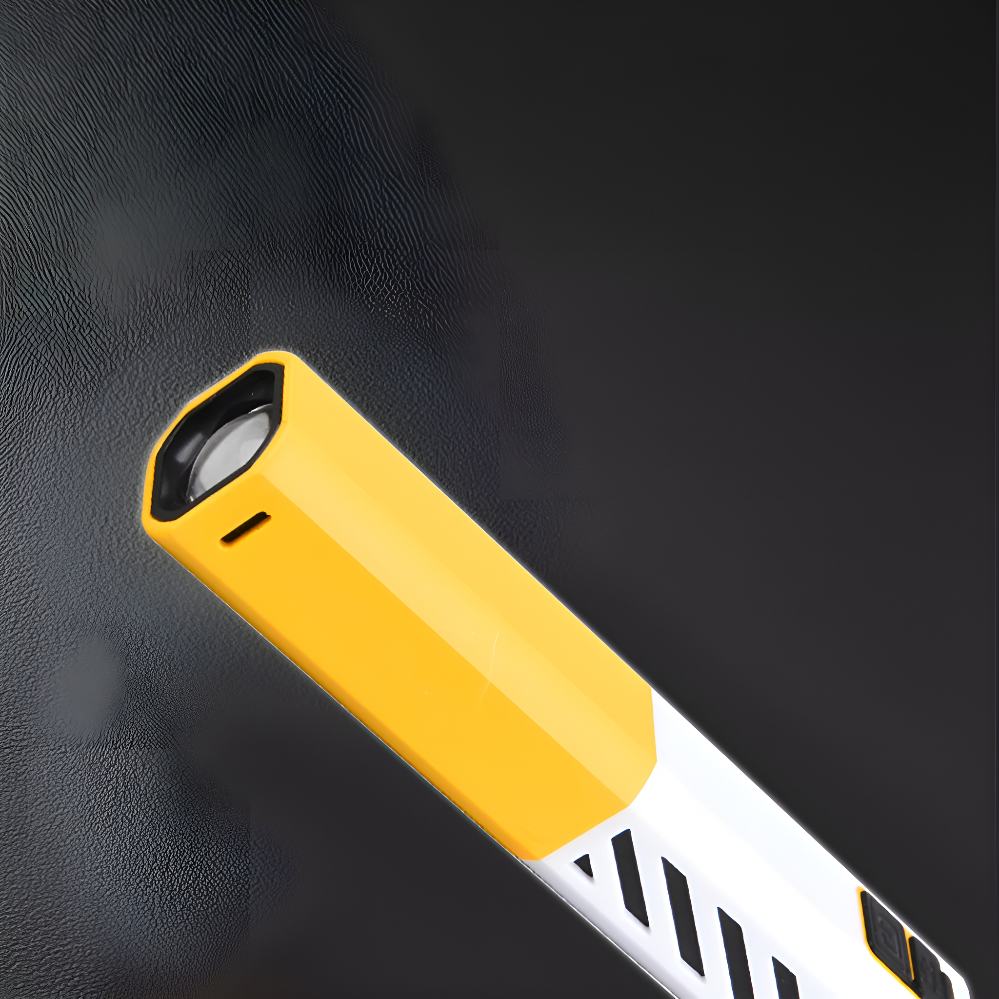 Ein gelb-weißes Taschenlampen-ähnliches Gerät mit schwarzem Hintergrund, von oben links nach unten rechts geneigt.