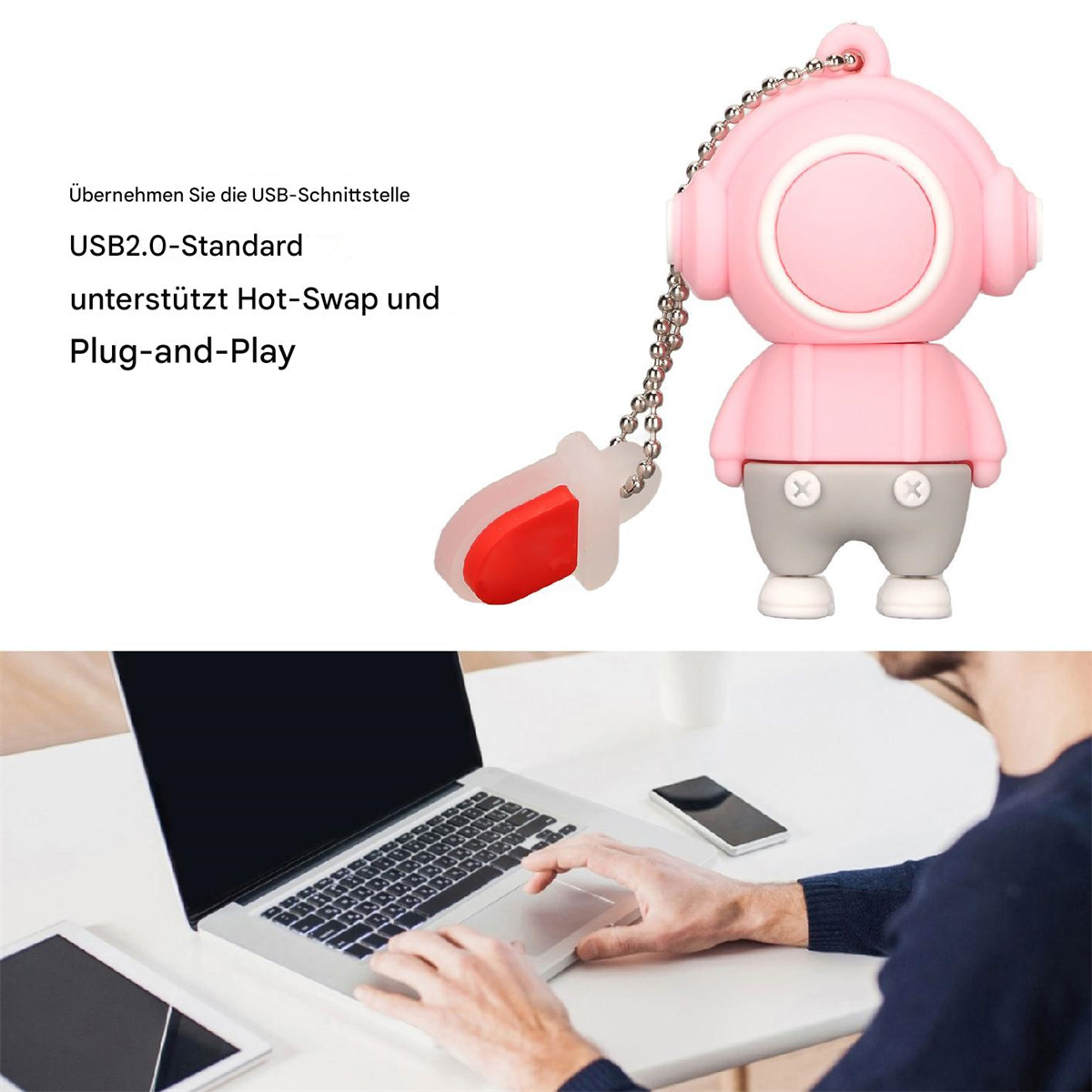 Rosa USB-Stick in Form eines Tauchers mit Silberkette. Im Hintergrund bedient eine Person einen Laptop.