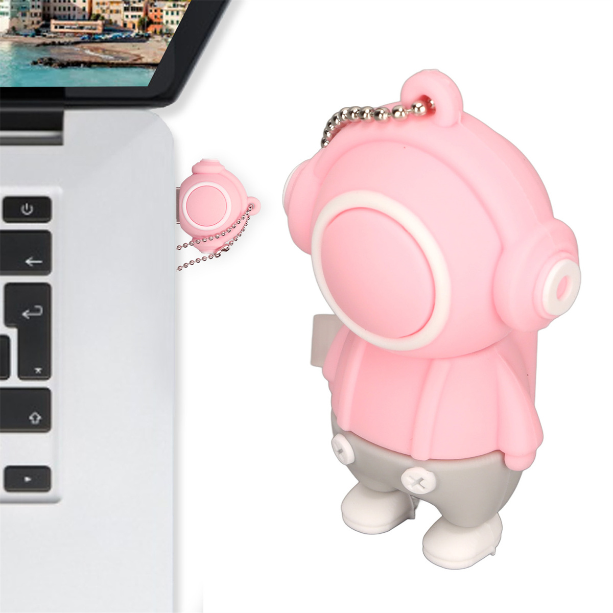 Ein rosa USB-Stick in Form eines Cartoon-Tauchers. Ein Laptop ist im Hintergrund.