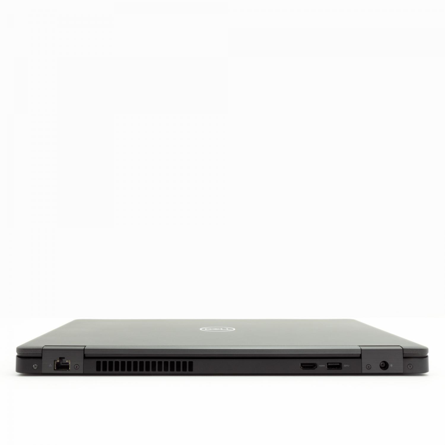 Geschlossener Laptop auf weißer Oberfläche. Der Laptop ist dunkelgrau und nach vorne gerichtet, kein Bildschirm sichtbar.