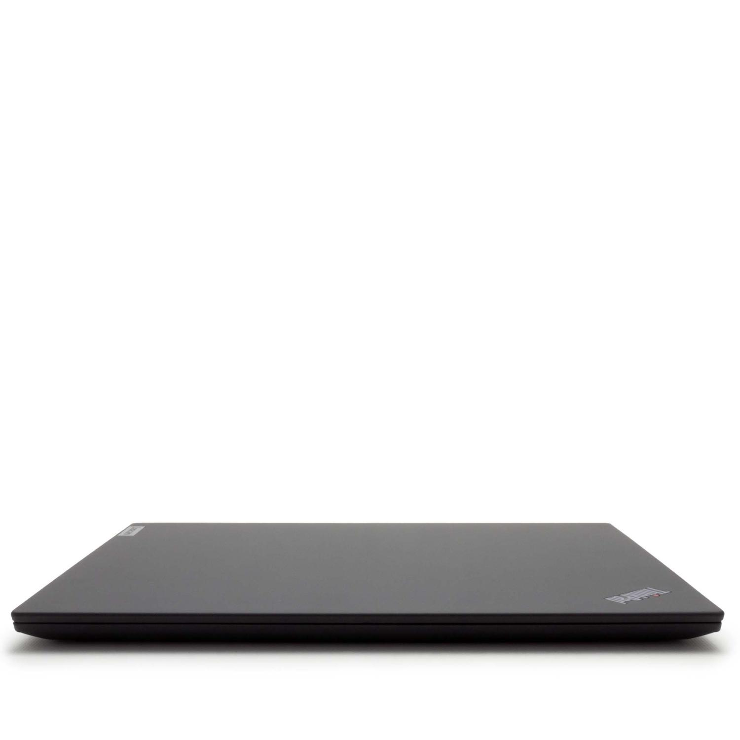 Ein geschlossener, dunkelgrauer Laptop liegt auf einer weißen Oberfläche.