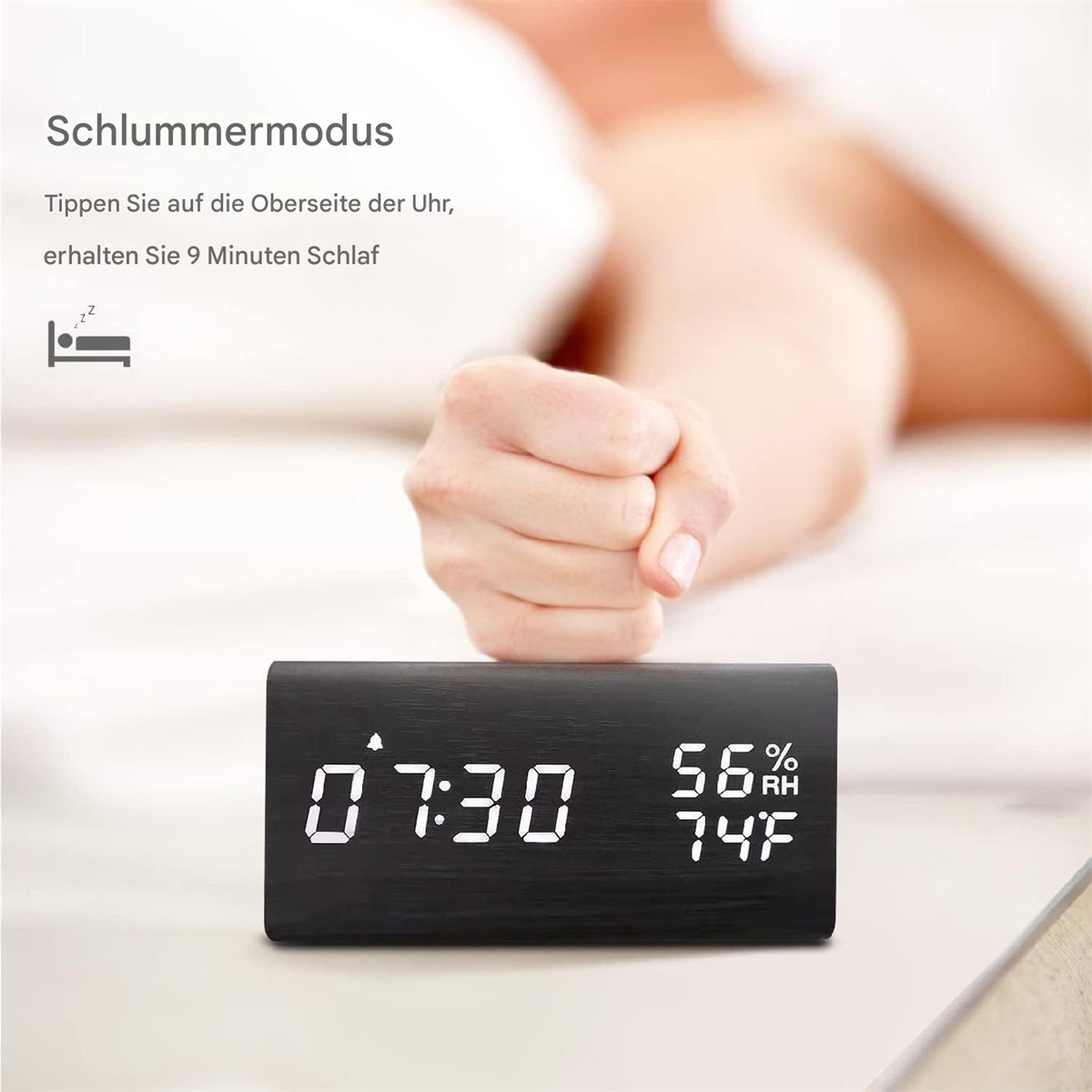 Schwarze Digitaluhr mit 07:30 und Temperatur/Luftfeuchtigkeit. Eine Hand greift.
