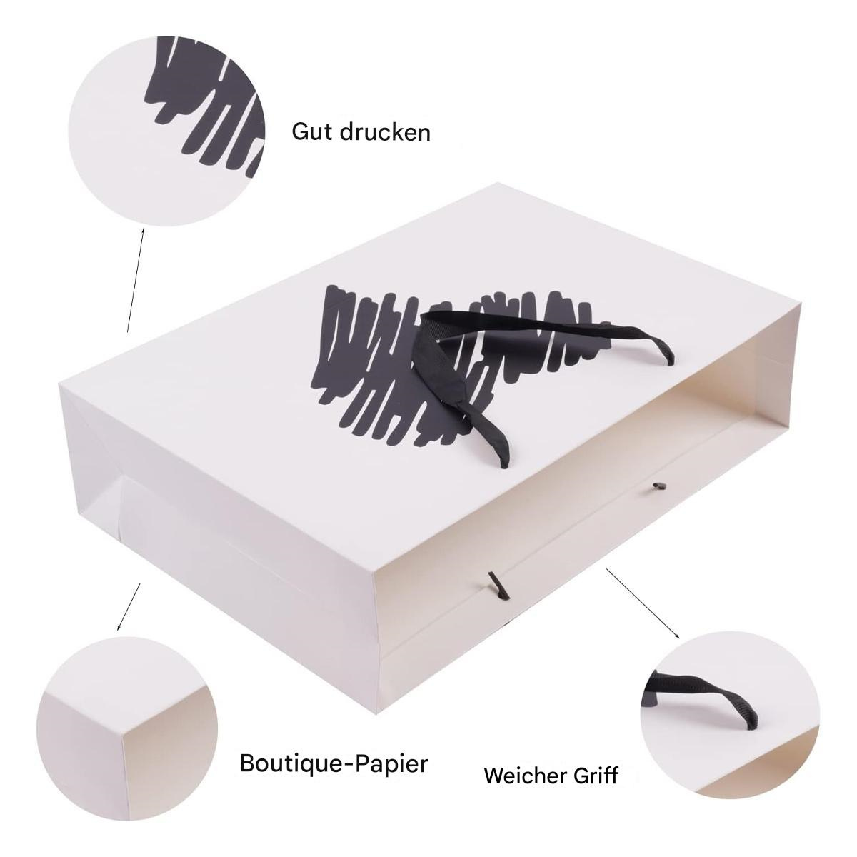 Weiße Geschenkbox mit schwarzem Herzdesign, einem schwarzen Band und Text. Weißer Hintergrund.