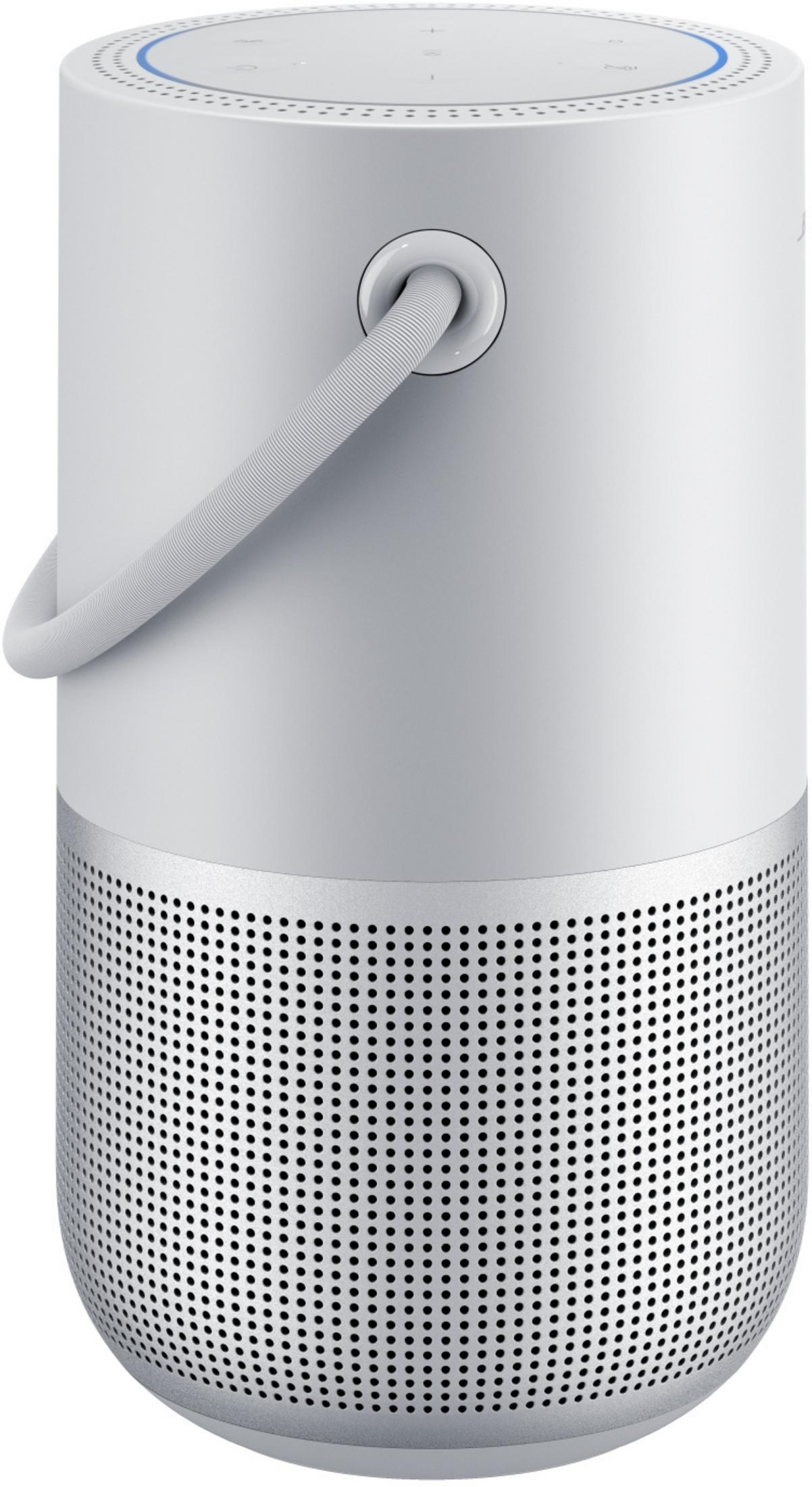 Witte en zilveren cilindrische speaker met een handvat. Blauwe ring bovenop.