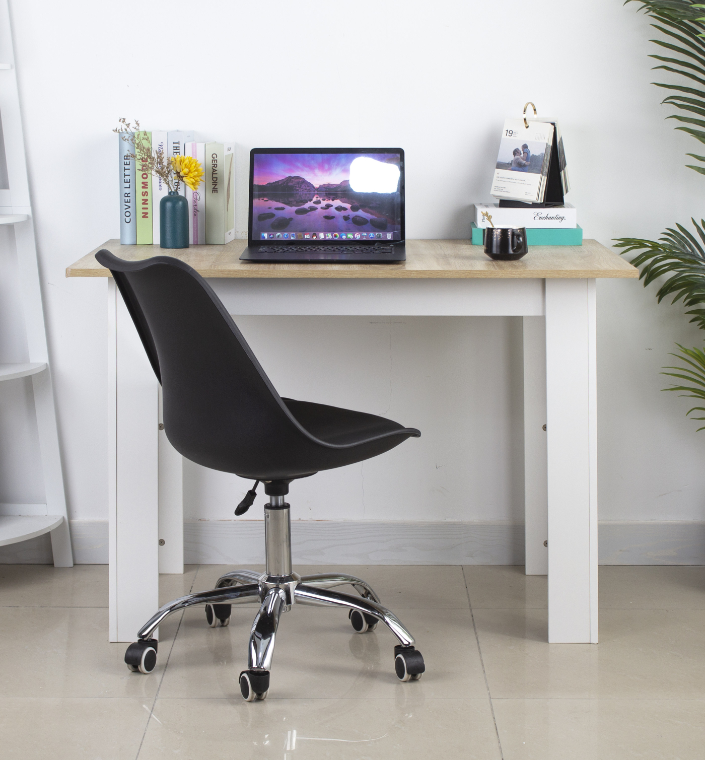 Office desk with laptop, chair, books, and decoration.  A modern workspace.