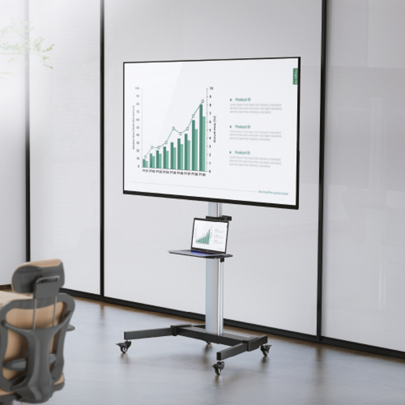A TV screen on a wheeled stand with a laptop shelf. The screen displays a chart.