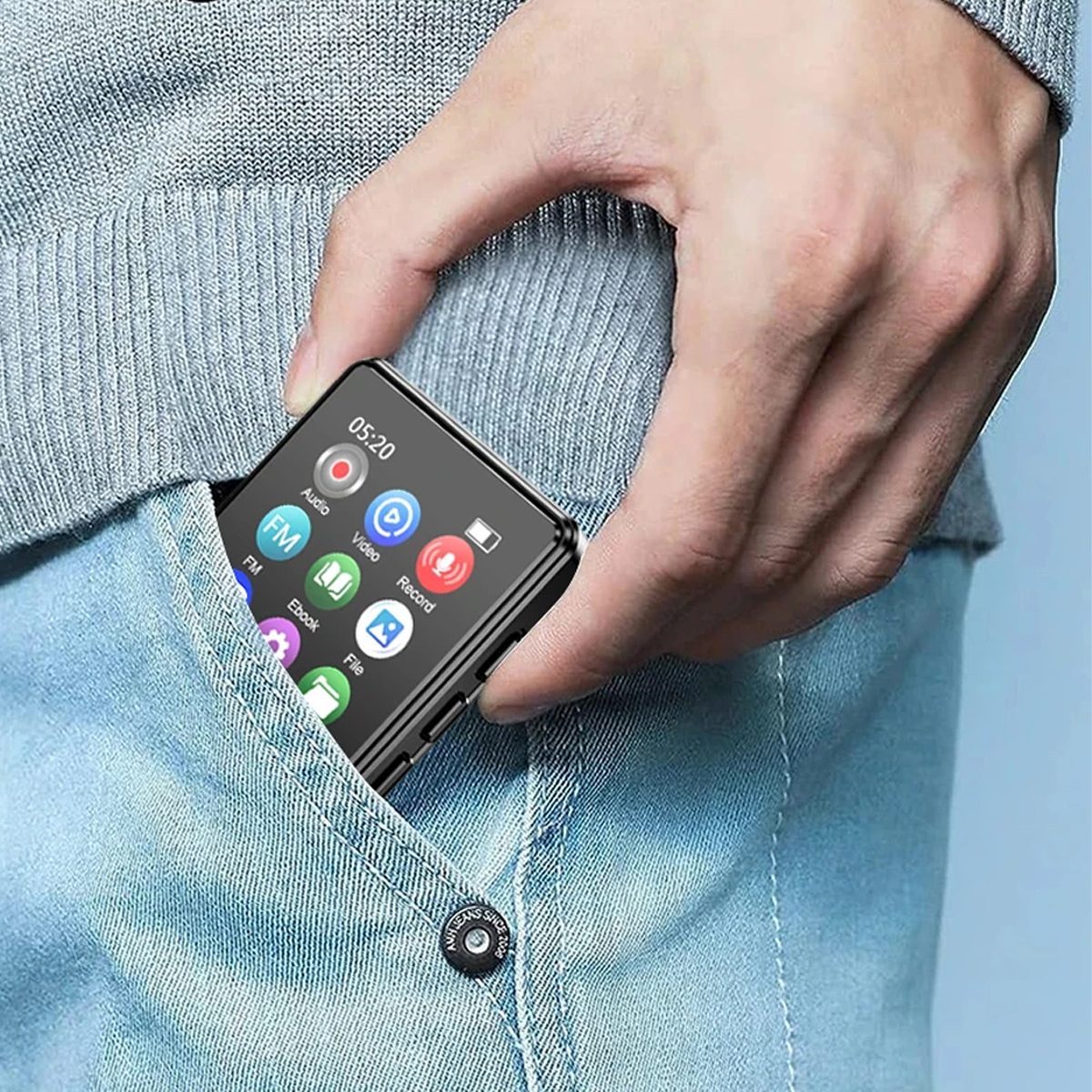 Eine Hand hält einen kleinen schwarzen Mediaplayer in einer Tasche. Der Player hat einen Bildschirm mit Symbolen.