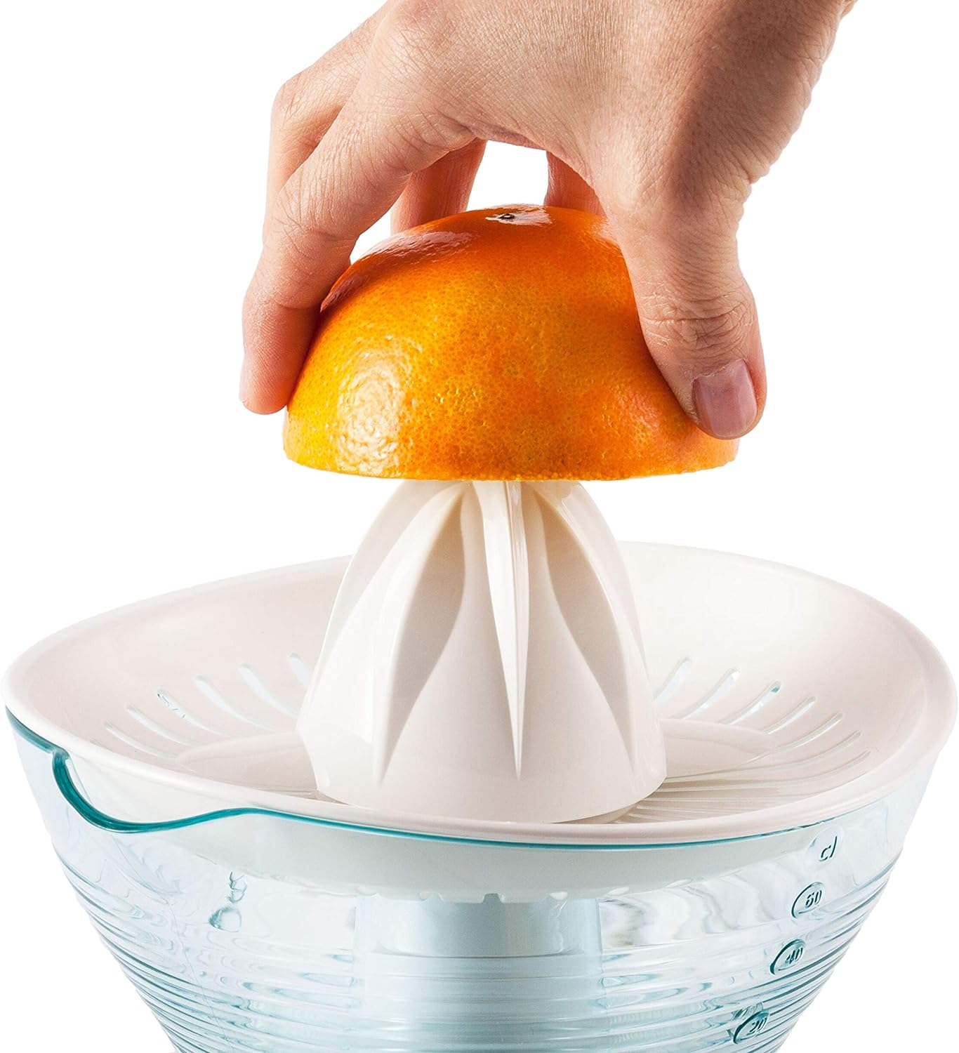 Ręka wyciskająca sok pomarańczowy do wyciskarki. Biała wyciskarka z przezroczystym kubkiem.