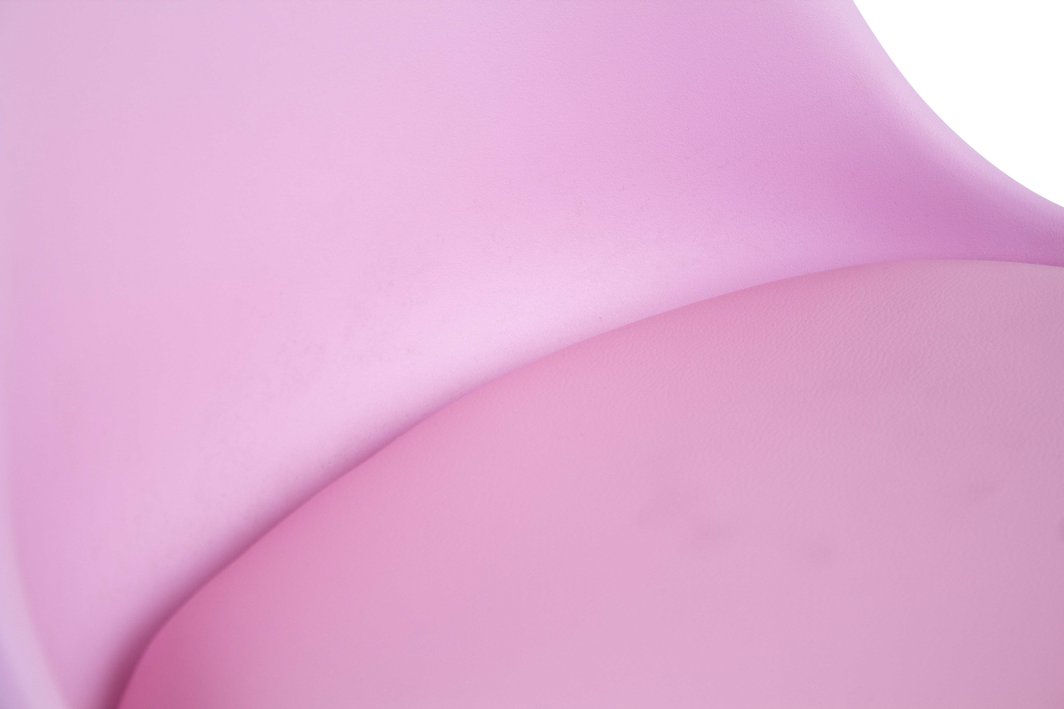 Close-up of pink curved surface, smooth and glossy.