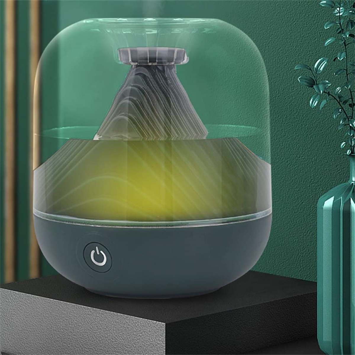 Ein Aromadiffusor mit tealfarbenem Sockel und einer transparenten, tealfarbenen Abdeckung. Es hat ein graues, konisches Element.