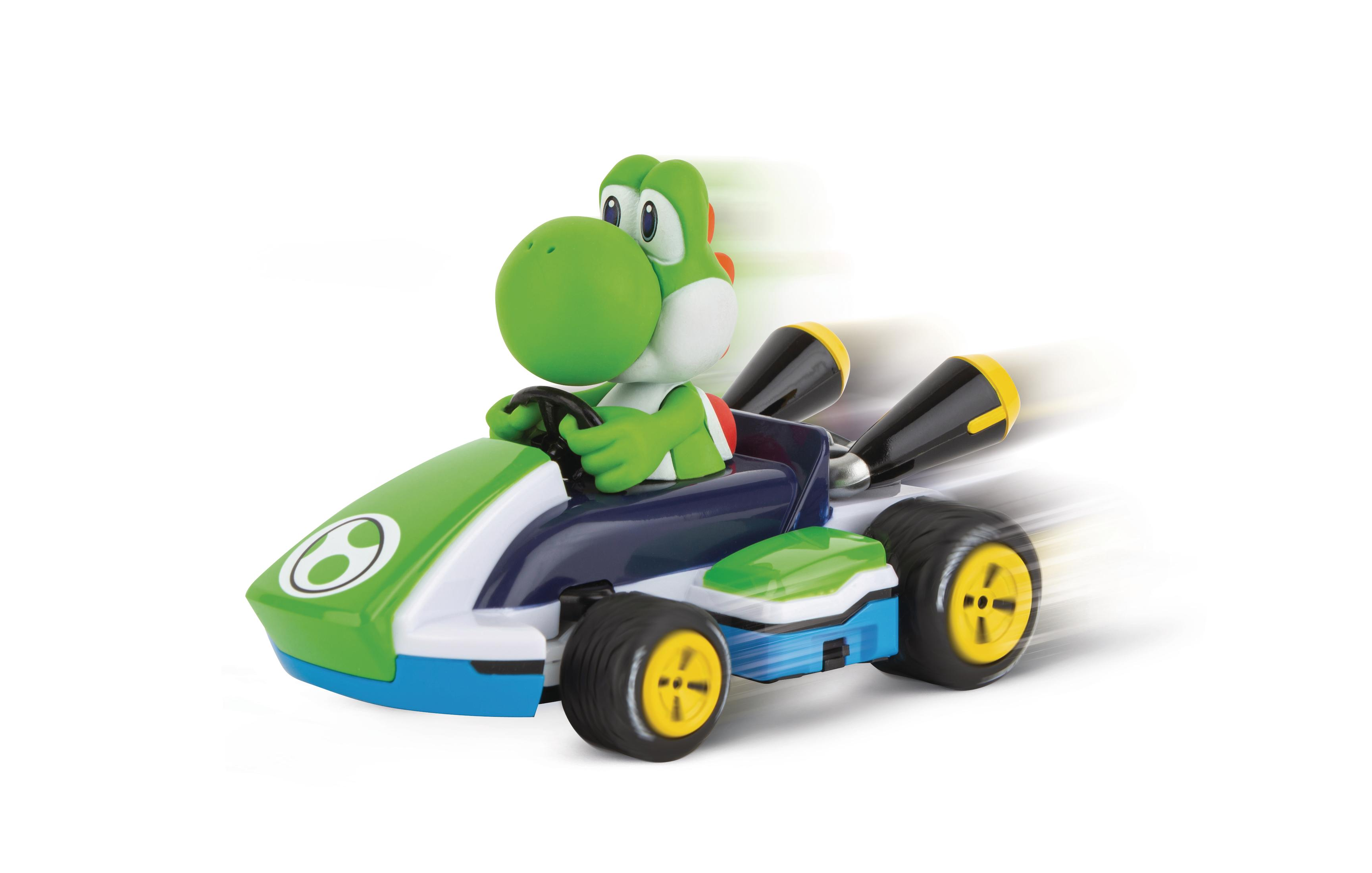 Juguete de Yoshi en un kart sobre fondo blanco, efecto de desenfoque de movimiento.