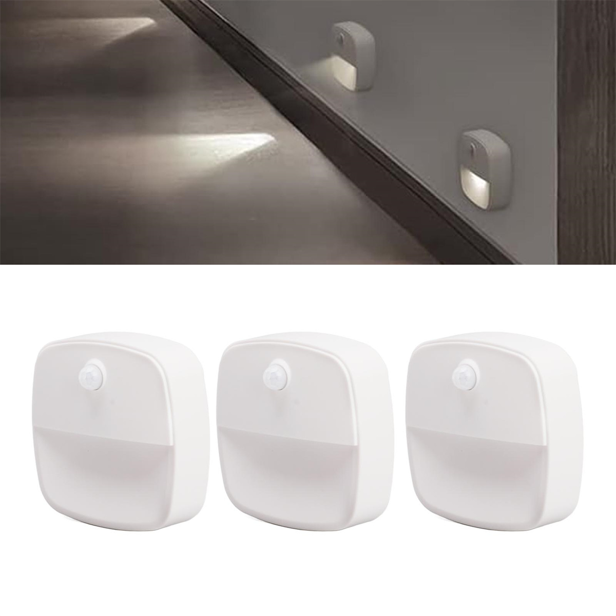 Drei weiße Lichter sind an einer Wand. Eines ist an der Wand, ein anderes auf dem Boden, das Licht wirft.