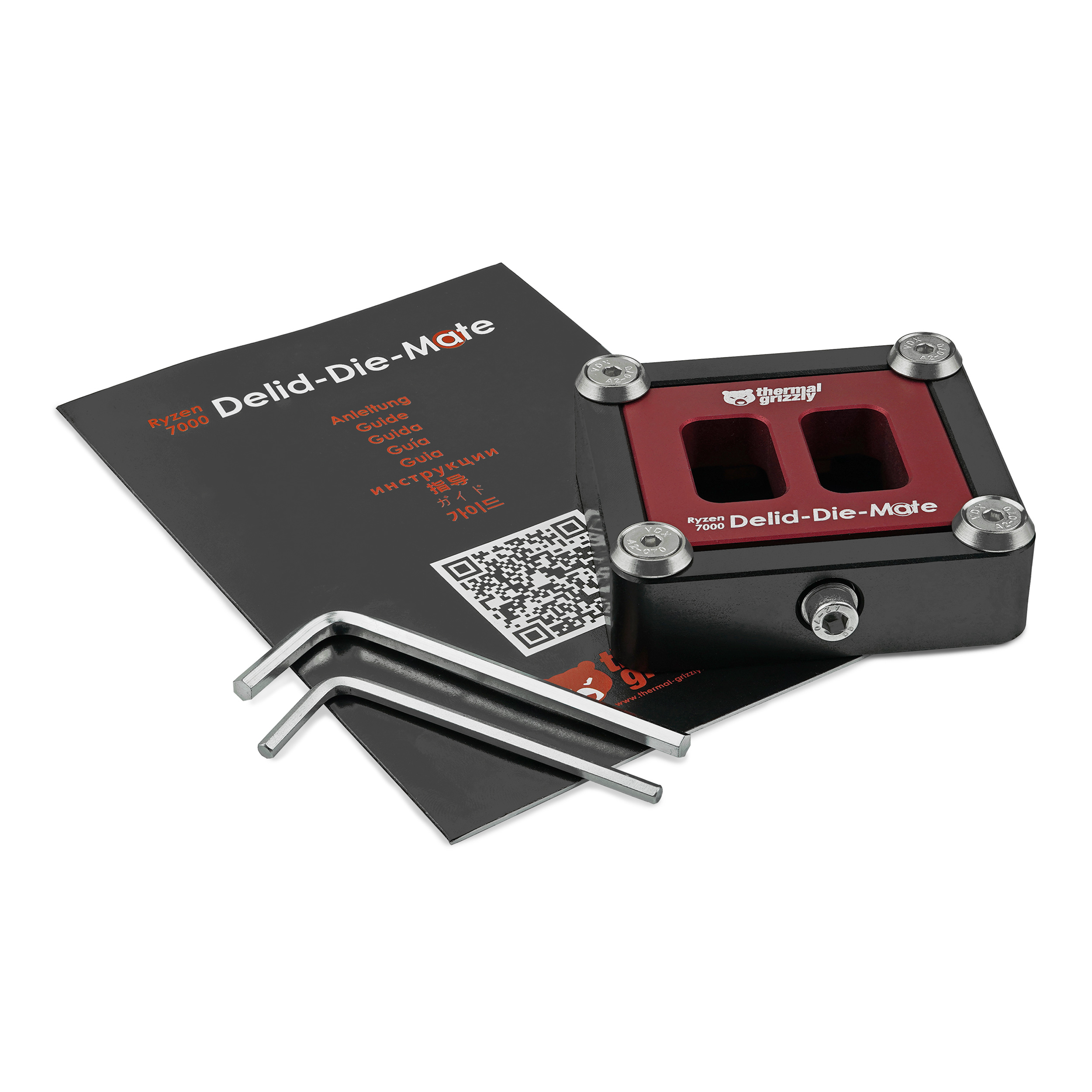Ein schwarzer und roter CPU-Kühler mit Werkzeugen und Anleitung auf weißer Oberfläche.