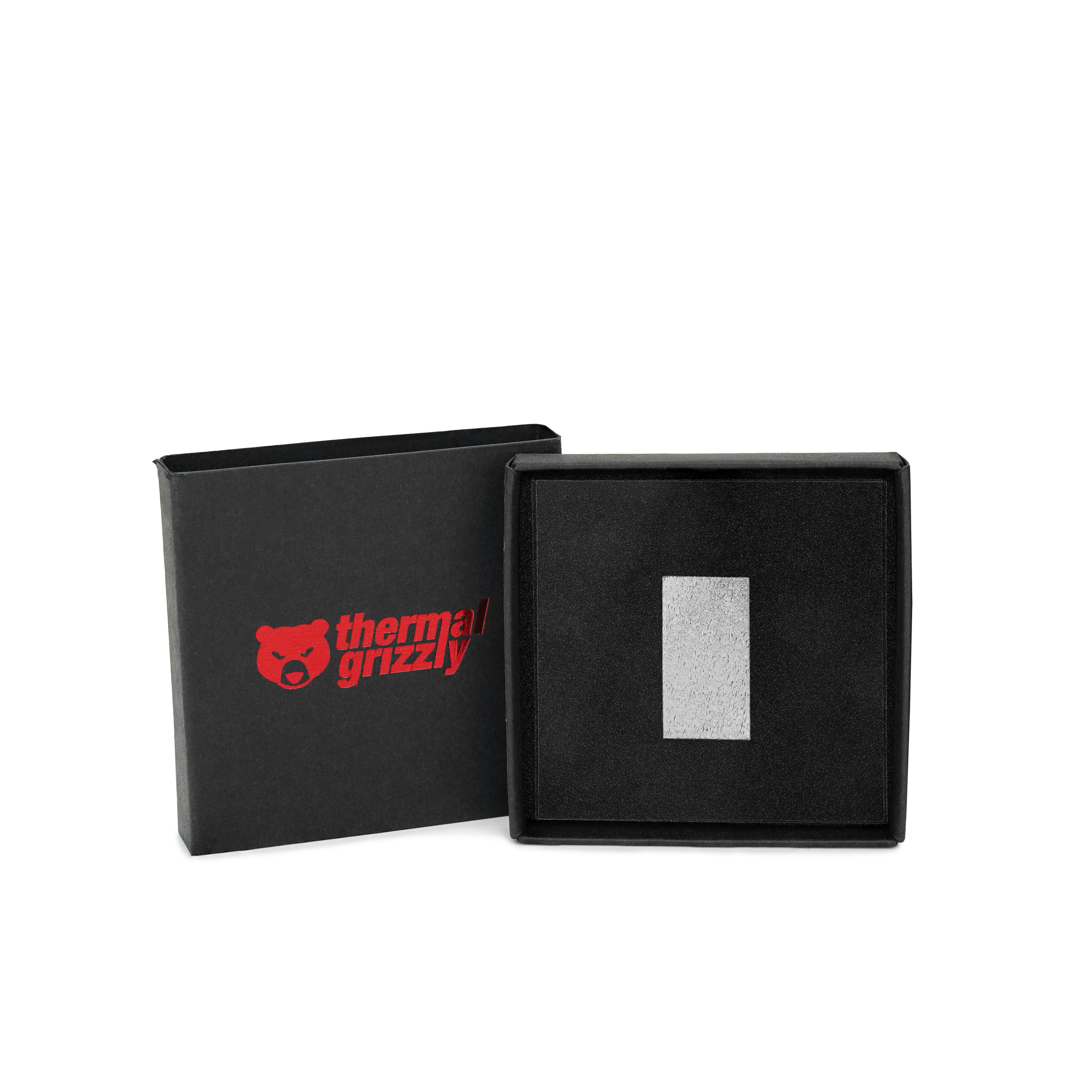 Thermal Grizzly logosu ve içinde küçük metal bir kare bulunan siyah kutu, beyaz bir arka plana karşı.