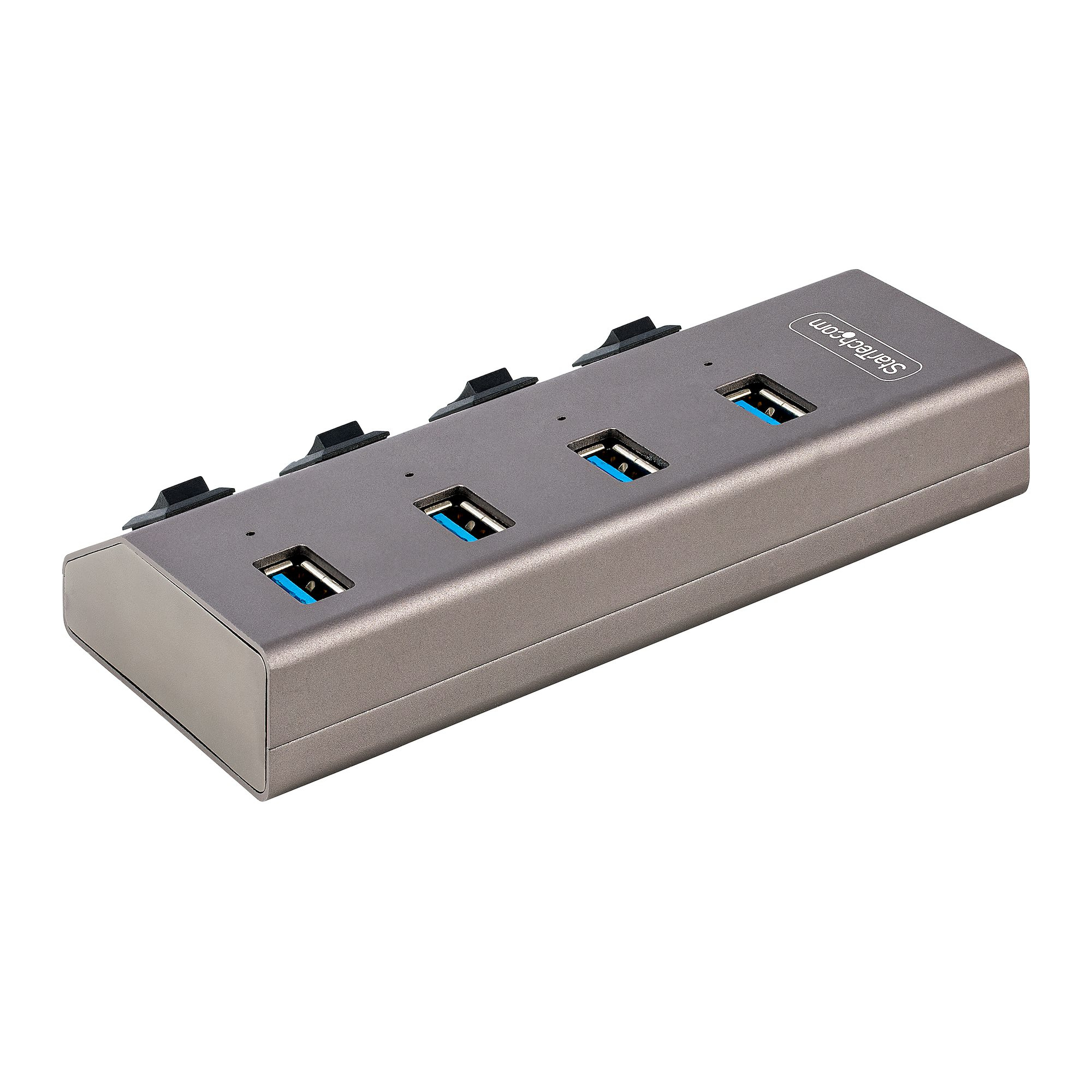 Grauer USB-Hub mit vier USB-Anschlüssen. Schwarze Gummipads oben, weißer Hintergrund.