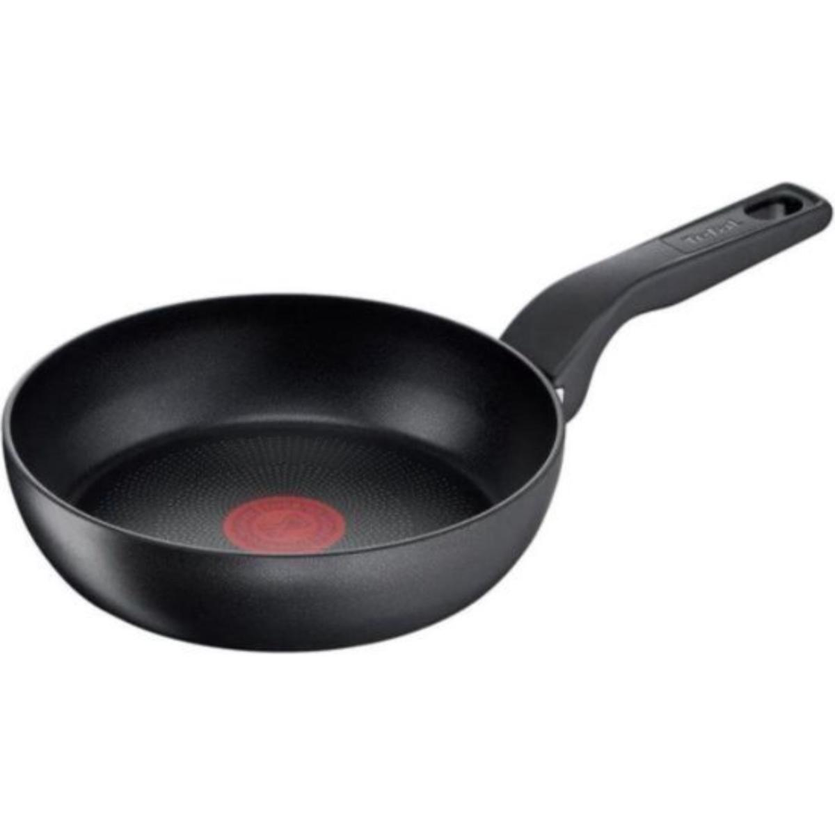 Black frying pan with a handle. Red circle in the center of the pan.