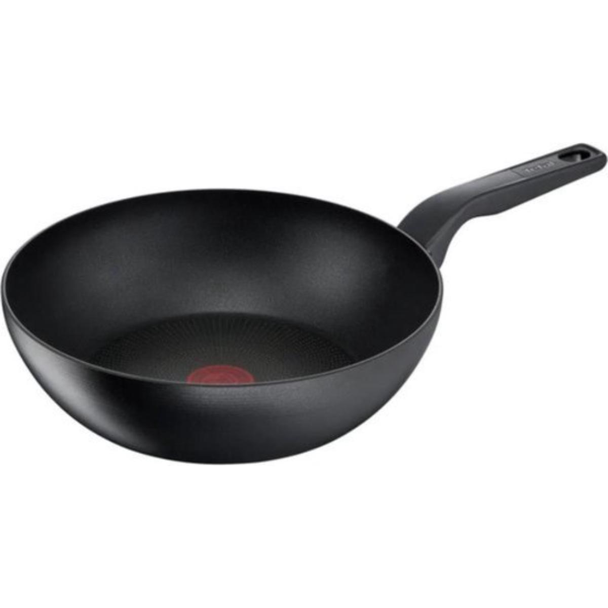 A black wok pan with a red dot in the center on a white background. The pan is tilted.
