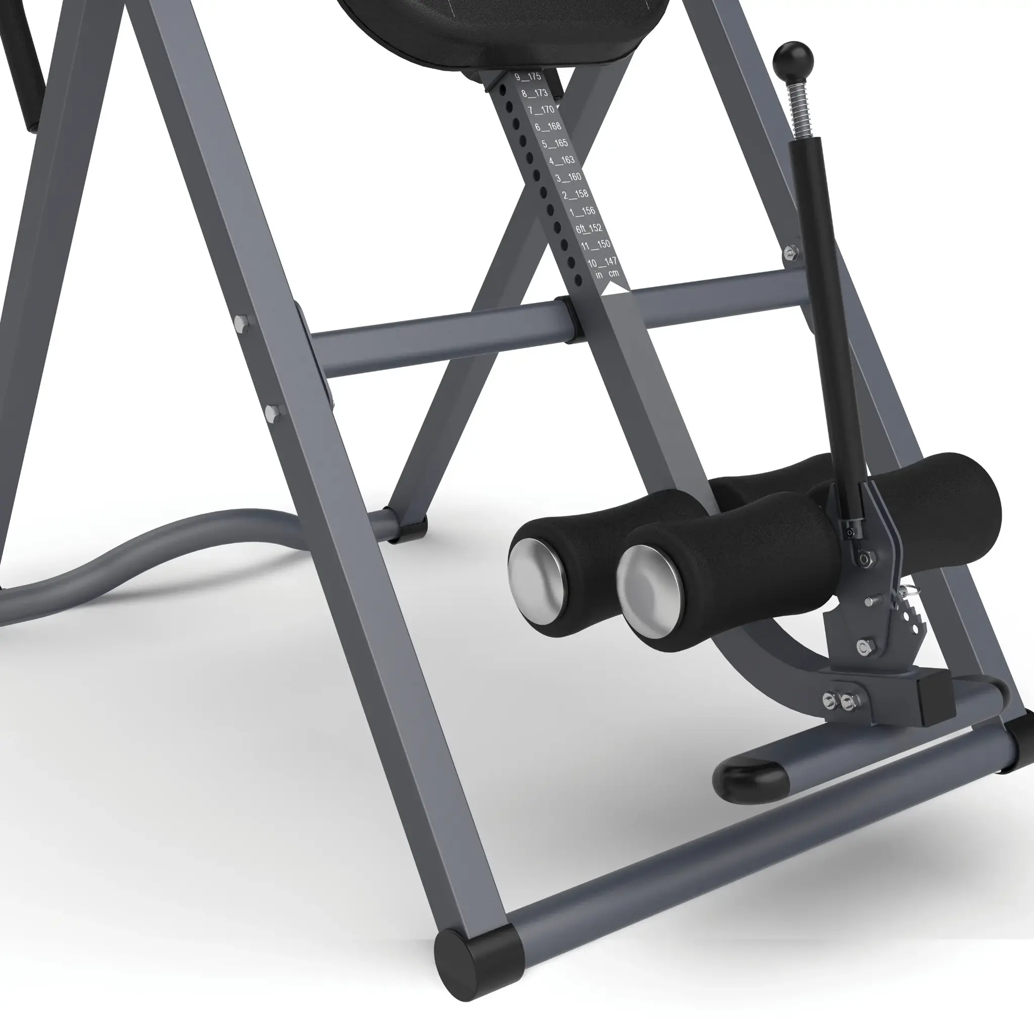 Inversion table with gray frame. Black leg supports and handle. White background.