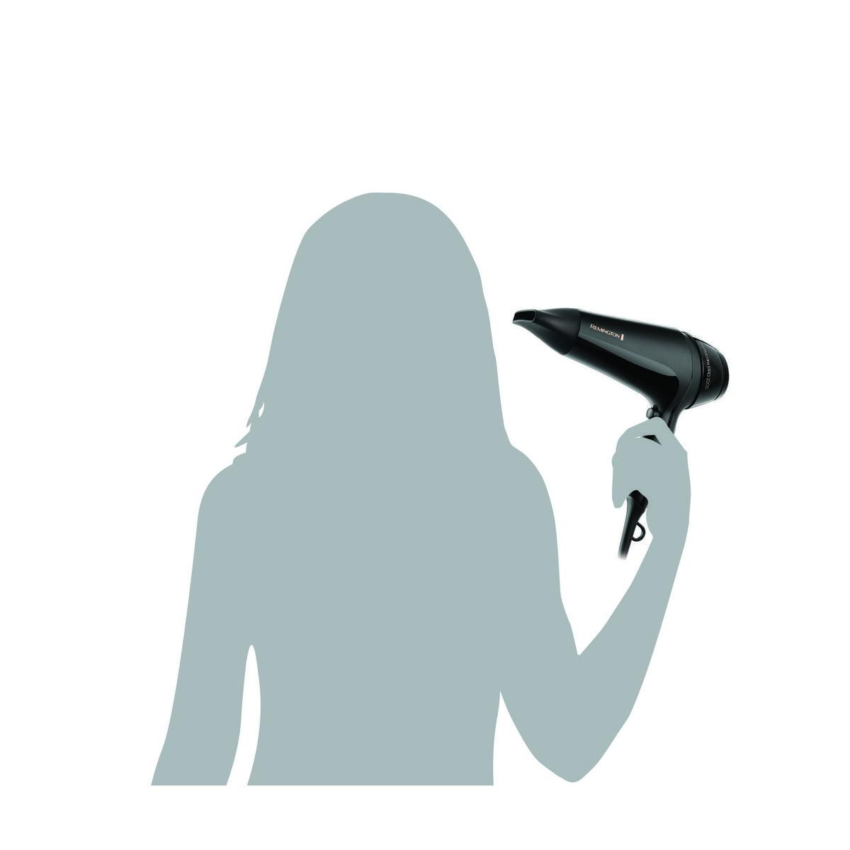 Sylwetka osoby trzymającej czarną suszarkę do włosów, z widoczną nazwą marki Remington.