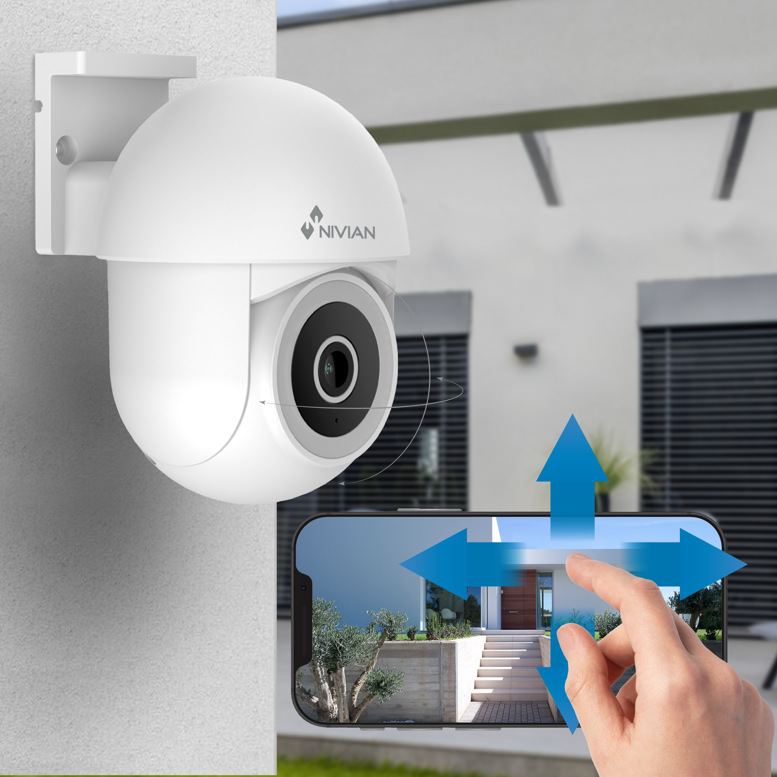 Una cámara de seguridad blanca en una pared, mostrando una casa en la pantalla de un teléfono.