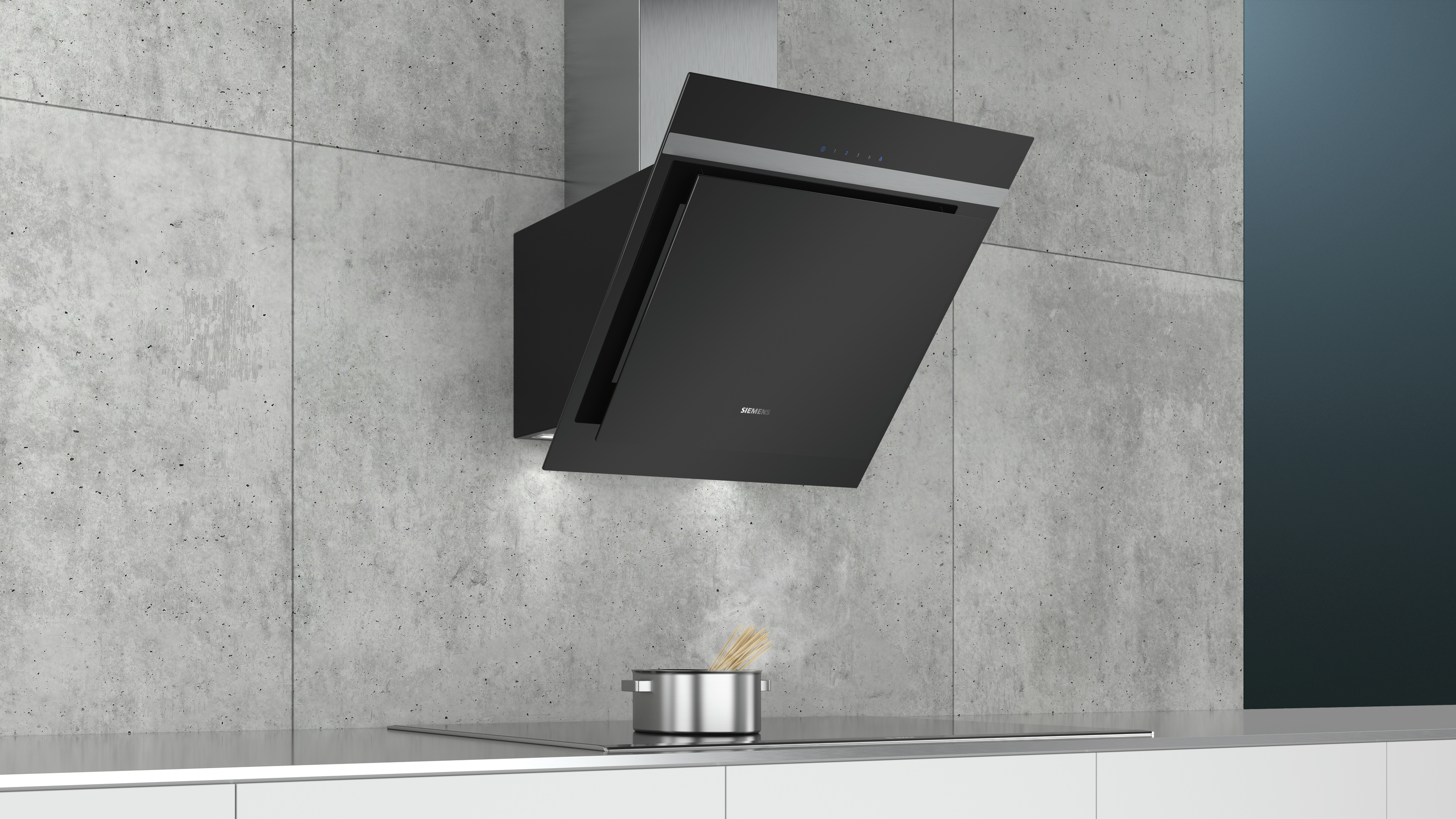 A black, angled Siemens range hood is mounted on a concrete wall above a stove with a pot.