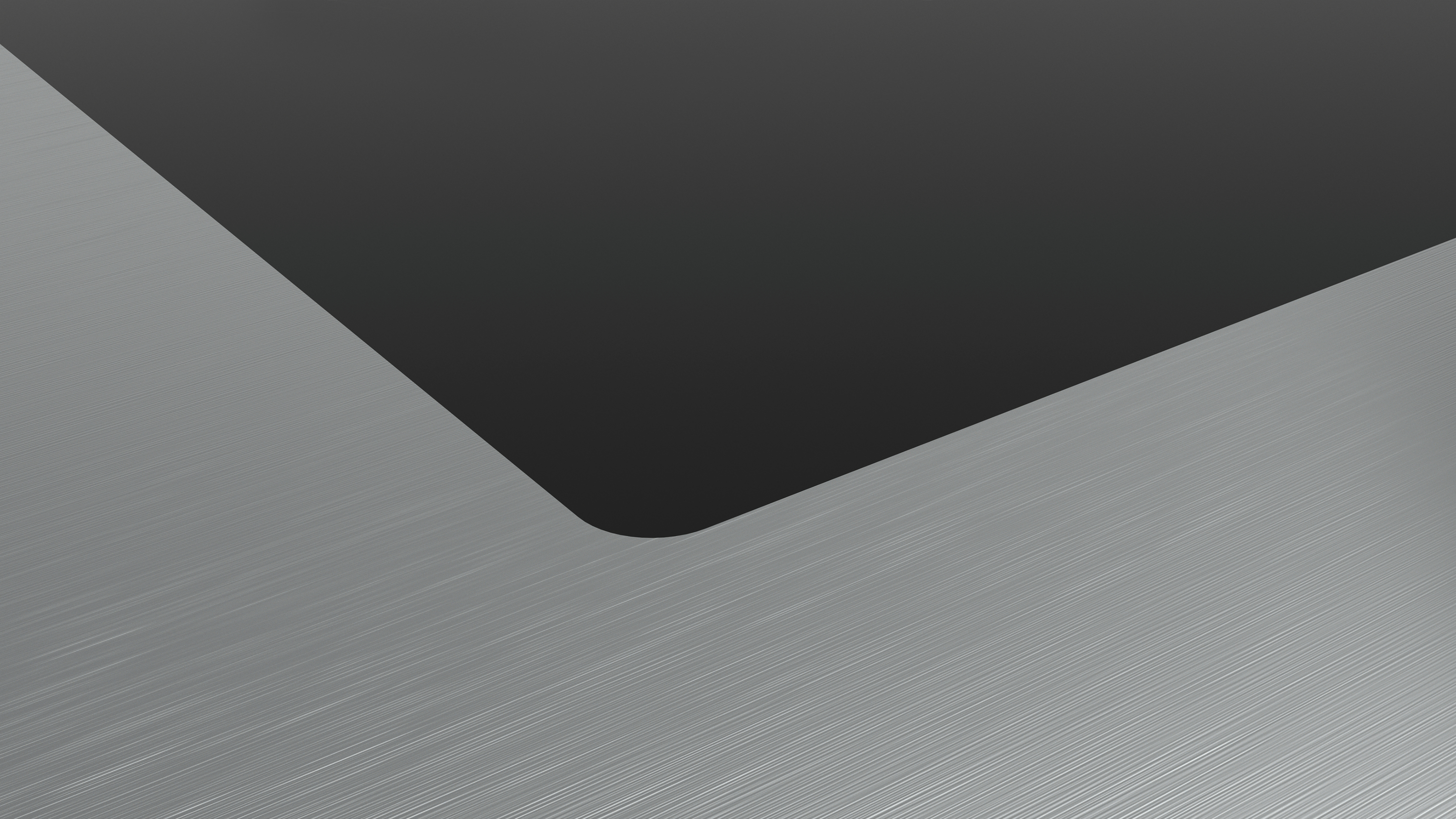 Uno sfondo astratto grigio scuro e argento. Una linea curva separa i colori.