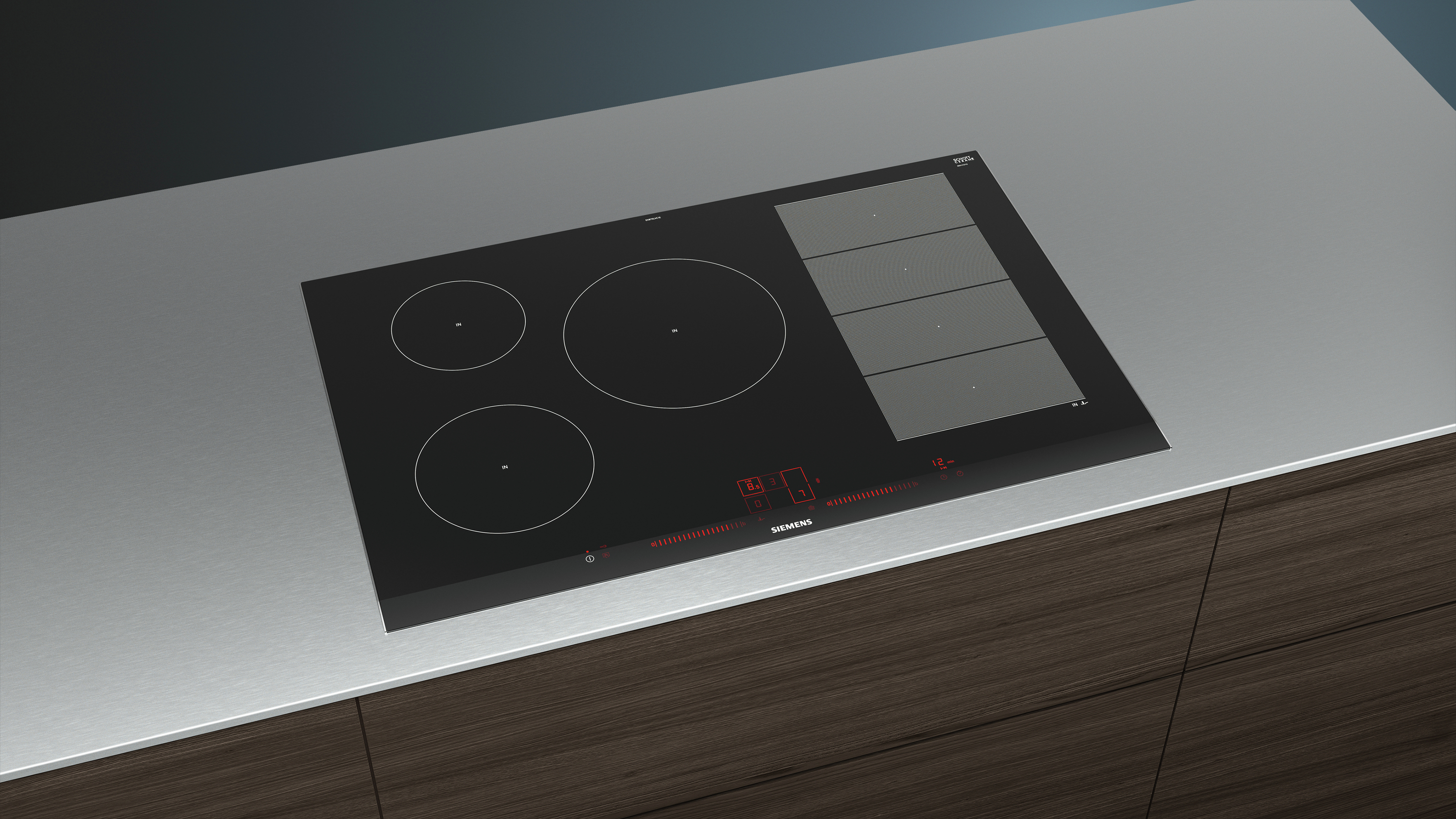 Czarna płyta grzejna z czterema okrągłymi palnikami na szarym blacie.