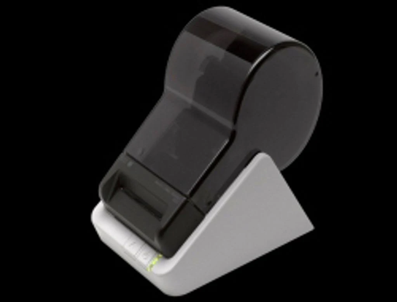 Black and gray label printer on a white angled stand against a black backdrop.