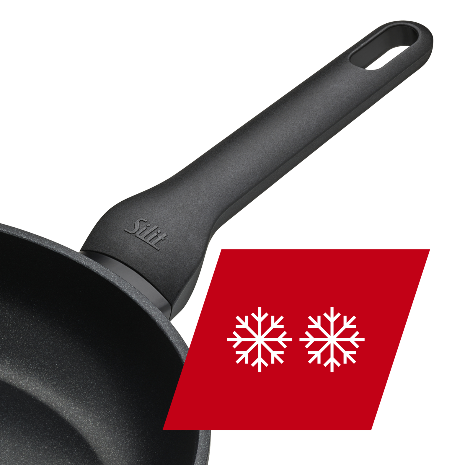 Schwarze Bratpfanne mit Griff und rotem Banner mit Schneeflocken, schwarzer Hintergrund.