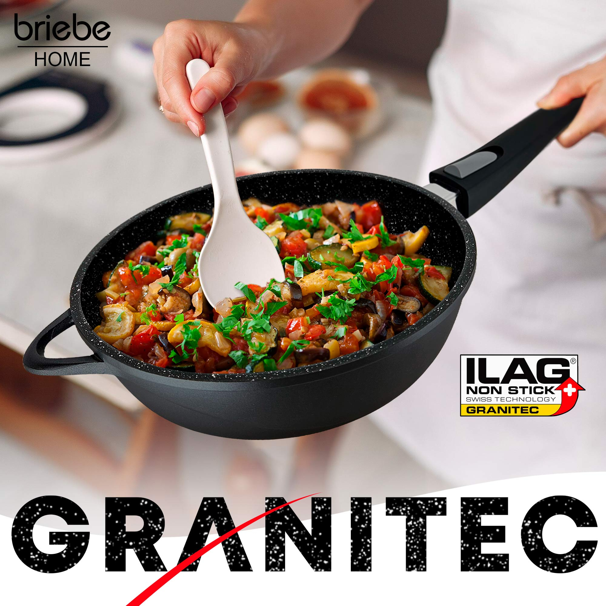Eine schwarze Pfanne mit Essen wird von einer Person gehalten, mit dem Text "GRANITEC" am unteren Rand.