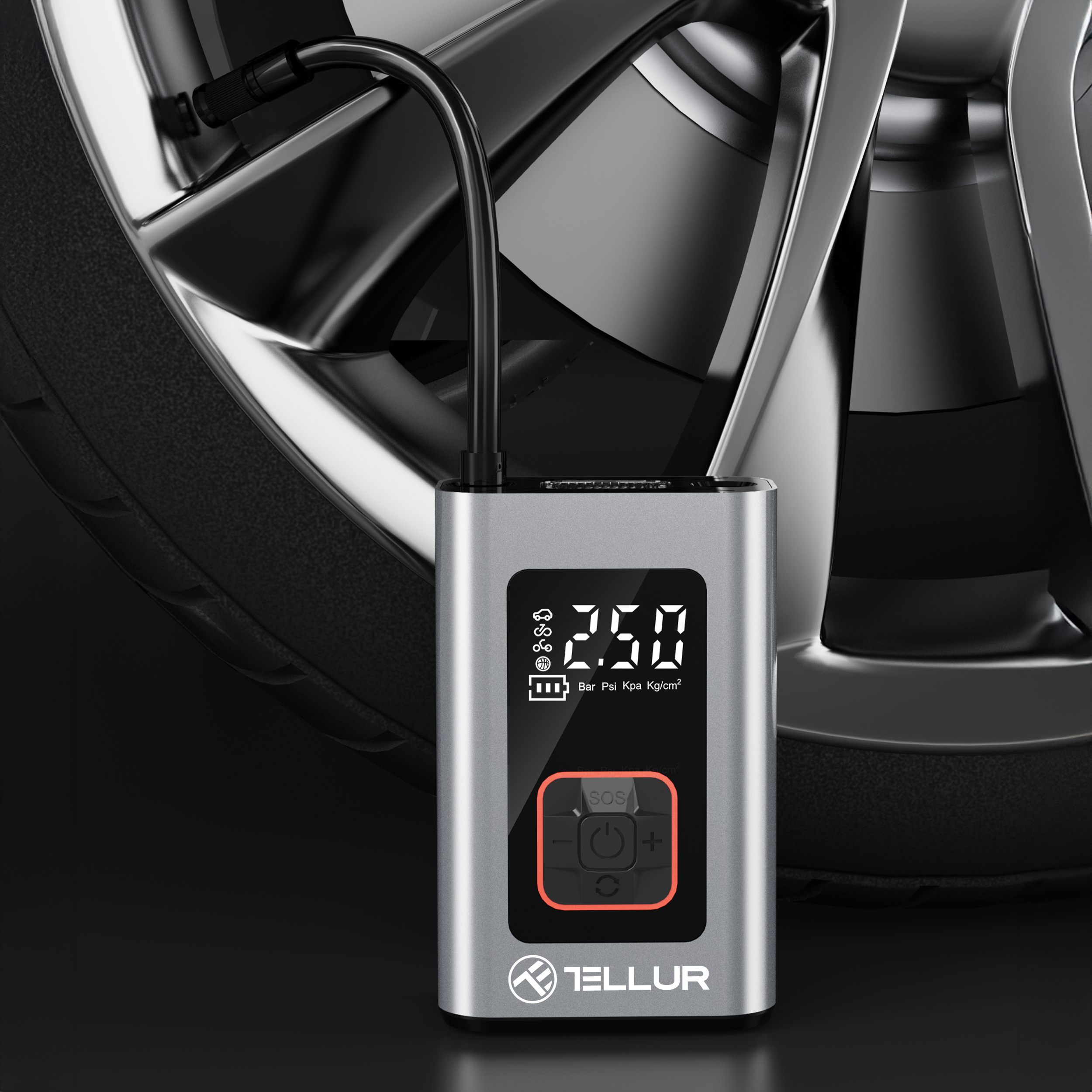 Srebrna pompka powietrza z wyświetlaczem cyfrowym. Pompa jest podłączona do opony. Tło jest ciemne.