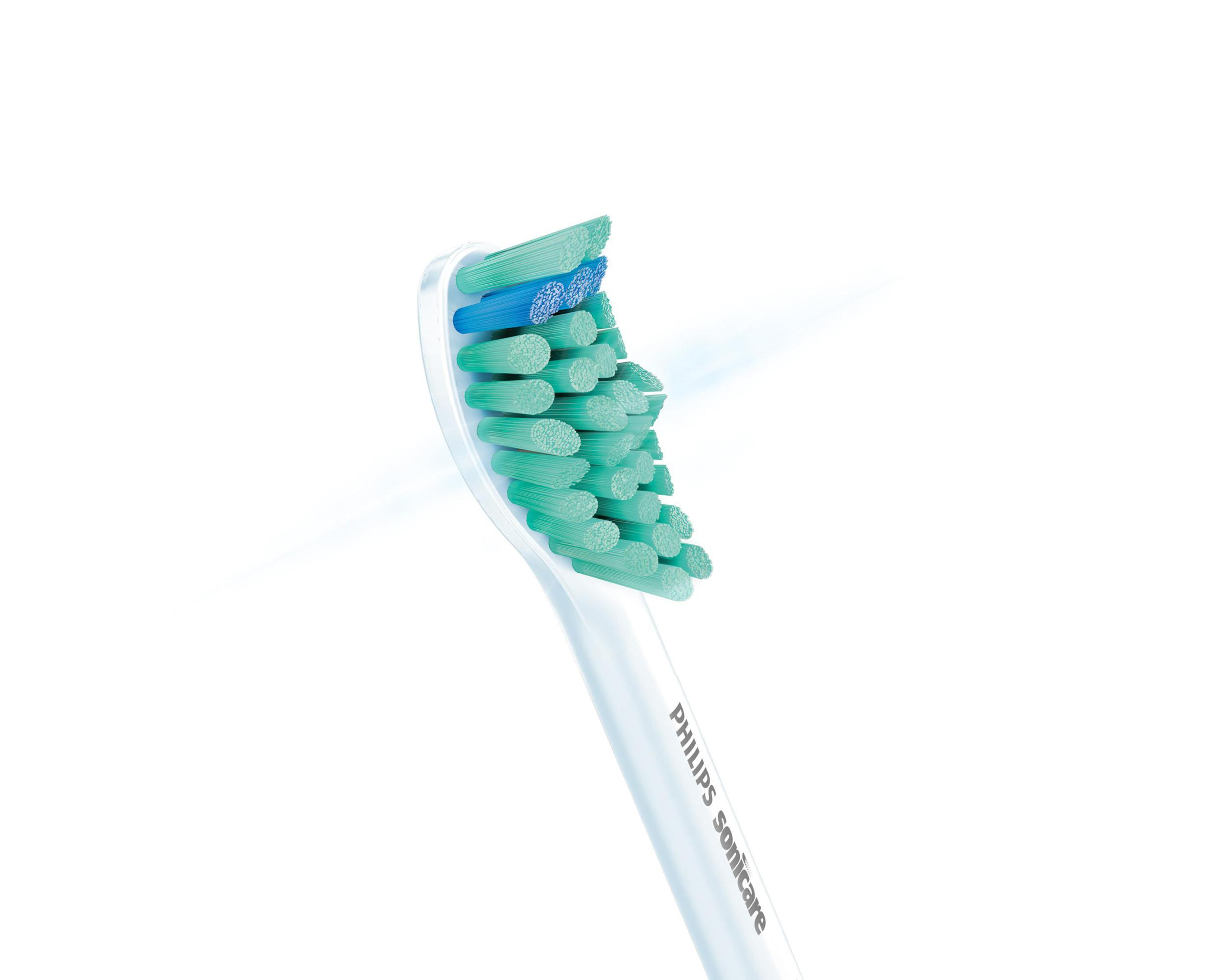 Primer plano de un cabezal de cepillo de dientes con cerdas verdes y azules.